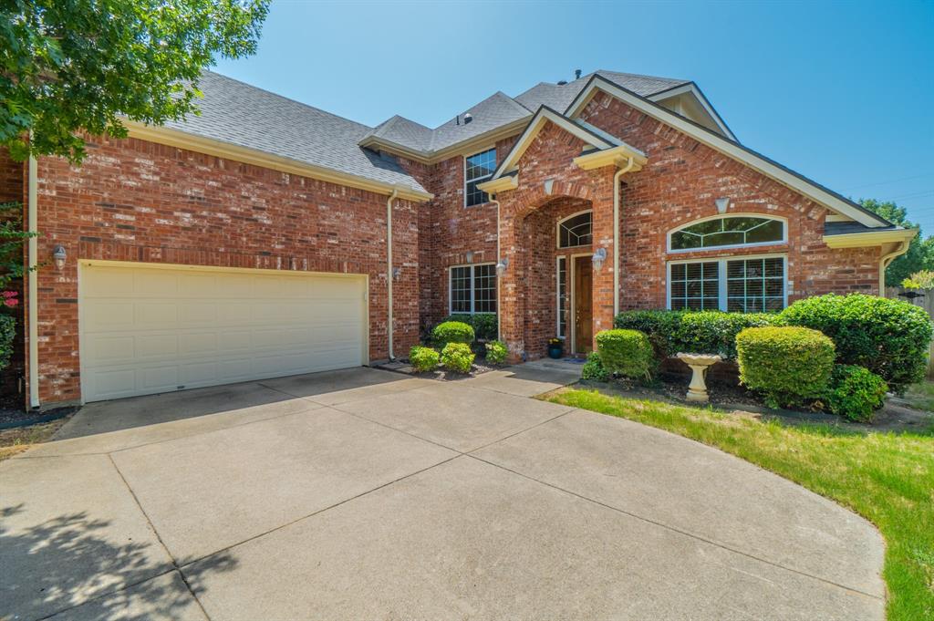 Welcome to this stunning one-owner Sandlin home tucked away in the sought-after Park Ridge Estates. From the moment you step inside, you'll be greeted by soaring ceilings, rich hardwood floors, a dramatic curved staircase, and walls of windows that flood the home with natural light.Designed for both everyday living and effortless entertaining, the spacious floor plan features 4 bedrooms, a private library with custom built-in bookshelves and cabinet lighting, plus an oversized upstairs bonus room perfect for a game room, office, media room, or second living area. The expansive kitchen is truly the heart of the home, offering abundant custom cabinetry, granite countertops, stainless steel appliances, double ovens, a center island, and an open flow into the impressive two-story living room, where a floor-to-ceiling custom entertainment center and fireplace create a stunning focal point. The desirable split floor plan provides a peaceful first-floor primary retreat while the secondary bedrooms are tucked upstairs for added privacy. Outside, enjoy a low-maintenance backyard and covered patio—the perfect place for morning coffee or evening relaxation. Enjoy a low-maintenance backyard with room to relax, entertain, and spend weekends doing what you love instead of yard work.With new carpet, a new roof, new HVAC systems, and two new water heaters, the major updates have already been completed, allowing you to move in with confidence. Within walking-distance proximity to Bell Helicopter, and minutes away from shopping, restaurants, an award winning school district and DFW Airport, the location cannot be beat. Immaculately maintained by its original owner, this exceptional home combines generous living spaces, quality craftsmanship, and timeless style in one of Hurst's most desirable neighborhoods.