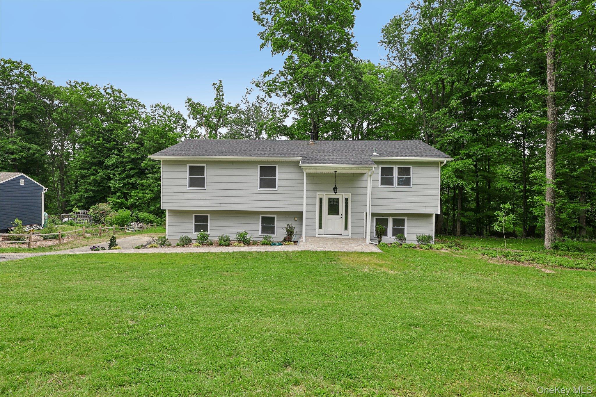 Beautifully renovated 3 bedroom raised ranch offering style, space and privacy throughout. This move in ready home features a stunning new kitchen with quartzite countertops, abundant cabinet space,and new appliances.  The updated bathroom includes elegant granite countertops and modern finishes.  The dining room opens with sliders to a deck overlooking serene private woodsperfect for relaxing or entertaining.  The lower level offers two additional finished rooms and a bath, idea for guests, a home office or recreation space.  Additional highlights include a full 2 car garage, new walkway, central air, and exceptional privacy with a peaceful wooded setting.
