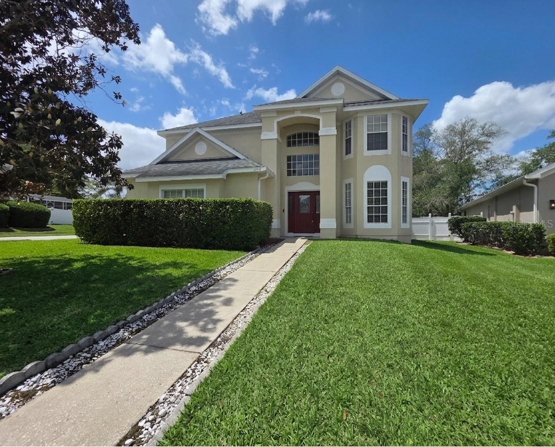 Experience the perfect blend of modern elegance and suburban tranquility in this stunning 4-bedroom, 2.5-bath residence located in the highly coveted Huntington Landing community of Lake Mary. Situated on a prime corner lot with a side-entry two-car garage, this home offers striking curb appeal and ultimate peace of mind with a new AC system (2025) and a new water heater (2025) and sprinkler system. The roof was installed in 2018. Step through the soaring high-ceiling entryway into formal living and dining areas featuring elegant walnut-toned wide-plank flooring and abundant natural light. The heart of the home is a bright, open-concept family room that flows seamlessly into a chef-inspired kitchen, fully reimagined with premium quartz countertops, a stylish designer tile backsplash, and brand-new stainless steel appliances. For those seeking extra versatility, the sun-drenched Florida room serves as the perfect home office or playroom, providing valuable bonus living space. Upstairs, the private retreat features plush new carpeting across all four spacious bedrooms. The spacious primary suite features a generous ensuite bath and a massive walk-in closet with a clever, direct-access opening to the upstairs laundry room for modern convenience. Beyond the front door, Huntington Landing offers a resort-style lifestyle with access to sparkling community pool, tennis and basketball courts, and a playground. Perfectly positioned in a top-tier school zone (Woodlands Elementary, Markham Middle, and Lake Mary High) and just minutes from premier shopping and dining in Lake Mary or Altamonte, 289 Hanging Moss Road is the move-in-ready home you’ve been waiting for. Schedule your private tour today!