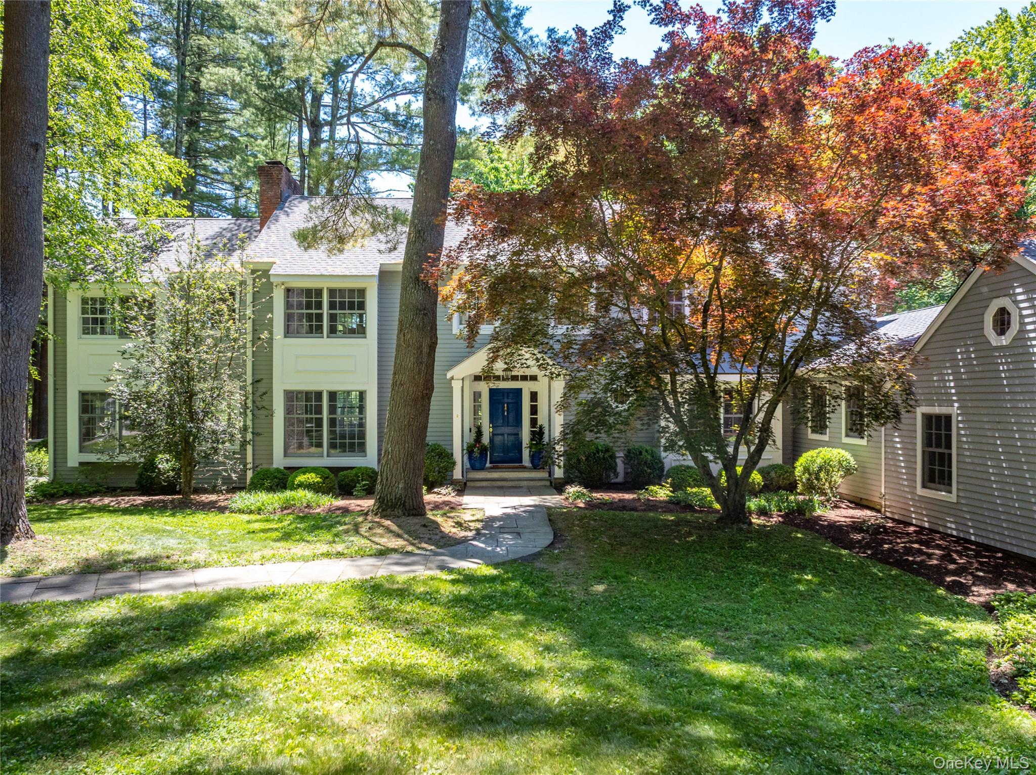 Serenely sited on 11.96 acres (which includes a separate vacant parcel) along a quiet cul-de-sac, this masterfully updated Colonial offers something increasingly rare: the unhurried rhythms of genuine country living, minutes from everything that makes South Salem one of Westchester's most cherished hamlets. Horses graze in the bucolic fields beyond, while the community's historic heart-which includes the storied Horse and Hound, the library, and the post office are in close proximity. Inside, the light-filled four-bedroom home strikes a perfect balance between grandeur and warmth. Exquisite custom millwork sets the tone throughout; from built-in cabinetry and crown moldings to pocket doors and graceful arched doorways, each detail a testament to the home's exceptional craftsmanship.The first floor unfolds from a gracious entry hall, with every room's windows framing views of white pine groves, the heated pool and spa, or Echo Farm in the distance. The formal living room with wood burning fireplace and the three-exposure great room are perfectly poised to host lively gatherings as well as quiet evenings in. The dining room seats twelve with ease, and a beautifully appointed marble bath is conveniently located off the front hallway.At the heart of the home, a stunning chef's kitchen features custom cabinetry, Sub-Zero and Wolf appliances, granite countertops and a fireside seating area. A breakfast room, butler's pantry, and flexible home office or homework space extend the flow, alongside a sunny family foyer with built-in storage, a generous laundry room, and an attached two-car garage.Upstairs, three family bedrooms, a hallway bath and a flex storage room (potential additional bath) share the floor with a primary suite that is genuinely surprising in its scope. From the bedroom with fireplace, new bath, dressing area and walk-in closets, French doors open to a private sanctuary—a spectacular, light-flooded office and gym with views in every direction.The grounds are as compelling as the home itself. Two landscaped acres of level lawns feature stately specimen trees, curated garden beds, and a stone terrace centered on the heated pool and spa. The remaining nine acres of woodlands offer a true sense of seclusion and endless opportunity for outdoor exploration.The mechanical systems and a wine cooler can be found in the unfinished basement. Household updates include: whole-house generator, roof, cedar siding, insulation, bathrooms, Marvin true-divided-light windows, indoor oil tanks, Ring security camera system and fresh interior paint throughout.