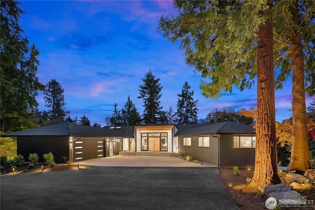 A truly unique "one-of a kind"  property in the coveted Holmes Point neighborhood, this like-new luxury estate offers an extraordinary combination of privacy, sophistication, and modern convenience on 1.5 gated acres. A secure entry and grand approach set the stage for this stunning 4,830-square-foot residence, where timeless mid-century architecture seamlessly blends with contemporary design.  Designed for exceptional living and entertaining, the home features four bedrooms, four bathrooms, and an impressive collection of upscale amenities. The gourmet chef's kitchen is complemented by a dedicated caterer's kitchen, while a third kitchen/bar area, glass wine cellar, and multiple gathering spaces create the ultimate entertainer's retreat. Luxurious Primary suite with it's own balcony and a spa-like bathroom!  Access to pool features walk-in shower and room to dry off! Walls of glass fill the home with natural light and capture serene lake views from the private estate setting. State-of-the-art smart home technology provides effortless control of zoned audio, heating and cooling, security, and more—all from your phone. Outdoors, enjoy resort-style living with a pool, expansive grounds, and perimeter privacy rarely found this close to the city. Huge level lot. Ample parking accommodates multiple vehicles, recreational equipment, and toys with ease.  An opulent in-city retreat offering luxury, innovation, and unparalleled privacy—this is Holmes Point living at its finest.