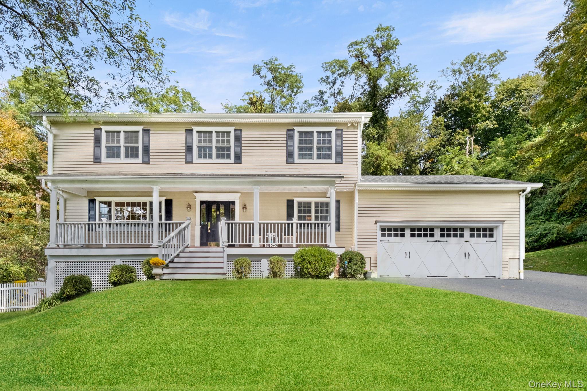 From the moment you turn down the long, secluded driveway toward 1 Sabbathday Hill Drive, the feeling is unmistakable: this is a retreat built for those who prize privacy, elevation, and quiet grandeur. Perched atop its own hill and surrounded by mature trees, the home sits back from the road with views visible from the wide front porch—a space that feels like your own private veranda overlooking acres of serenity.Inside, the home welcomes you with classic Colonial form and rich flexibility. The main level offers distinct zones—formal living and dining rooms, a family room ideal for gathering, and an eat-in kitchen that flows with ease. Upstairs, all four bedrooms are generous in size; the renovated primary suite and a sizable hall bath speak to refined updates amid timeless bones. The basement has the potential to expand your footprint considerably—perfect for a media room, gym, or creative studio. Here lies the hidden power of this property: space that grows with your vision.Yet it’s not just seclusion that sets this home apart—it’s connection. You’re roughly 16 minutes from the Goldens Bridge Metro-North, and about 15 minutes from the Katonah station, giving you reliable train access without sacrificing peace. Want to cross over into Connecticut? You’re close to Ridgefield, a charming New England town renowned for its historic Main Street, a thriving arts and theater scene, and boutique shopping.And just beyond that, Danbury adds the scale, amenities, and cultural vitality you’d expect from a city that blends history, parks, shopping, and easy access to Candlewood Lake and surrounding trails.Location-wise, Sabbathday Hill gives you the best of both worlds. A quiet, tucked-away neighborhood setting that feels removed yet remains minutes from Route 35, commuter arteries, local dining, schools, and recreation in both New York and Connecticut. In this spot, you can exist in retreat mode without ever losing touch with the everyday.This is more than a home—you’re buying into a lifestyle: privacy, flexibility, and access, all wrapped in a setting that feels timeless. 1 Sabbathday Hill Drive is rare. It’s the kind of place you visit in January and still feel like you’re in a summer escape.