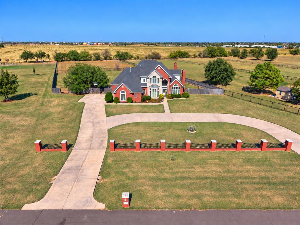 A rare find in NW Norman on 2 acres with room to spread! This home  offers over 3,400. s.f. and is adaptable to your lifestyle! Expansive windows with transoms allow for wonderful natural light throughout the home and offer awesome views of the pool and landscape. Versatile spaces offer multiple living areas, two with French doors for privacy offer an exceptional opportunity for 2 home offices, hobby room or play space! The spacious fifth bedroom upstairs also makes an ideal game or media room, complete with walk-in storage. So many updates including a totally renovated kitchen with top of the line appliances featuring a Thermador gas cooktop, double ovens, an ice maker, and 2 pantries! Storage is a standout throughout this home, with walk-in closets in every bedroom, a generous primary closet, and a large upstairs linen pantry. The primary bedroom enjoys the views of the pool and landscape and has direct access to the patio and a large luxurious primary bathroom and closet. There are 4 bedrooms upstairs. The back patios provide space to relax and entertain beside the pool and waterfall feature. A separately fenced part of the yard offers many possibilities, including a practice field or dog run. A whole-home generator adds peace of mind. Plus a 3 car garage, an outbuilding for storage and in-ground storm shelter!
