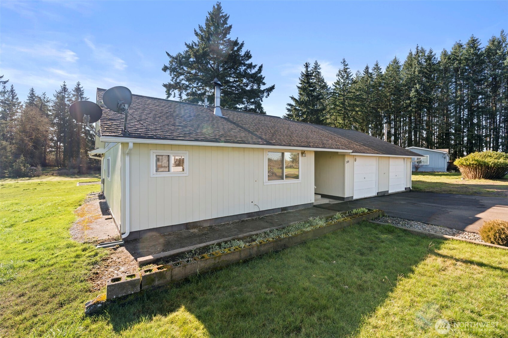 If you are looking for peace, calm and the luxury of slower paced living, look no further. Peaceful country living meets move-in ready comfort at 209 Drews Prairie Rd! This charming 3-bedroom, 1-bath home offers 1,224 sq ft on just shy of 1 acre in a quiet Toledo setting. Fresh interior paint and easy-care laminate flooring create a clean, inviting feel, while the open-concept layout offers comfortable one-level living.    Step outside to the covered deck and take in the gorgeous territorial views, the perfect place to relax and enjoy the peaceful surroundings. An extended breezeway adds convenience and connects to the garage. A brand-new 30-year roof with transferable warranty will be installed prior to closing — buyer may choose the color!    Storage and hobby space abound with multiple outbuildings plus a newer 40x22 metal shop. As the seasons change, cozy up beside the warmth of the wood-burning stove. Enjoy the tranquility of country living with the convenience of being just minutes to town, easy I-5 access, and high-speed internet through ToledoTel. A wonderful opportunity to add your own touches and make this peaceful retreat home!