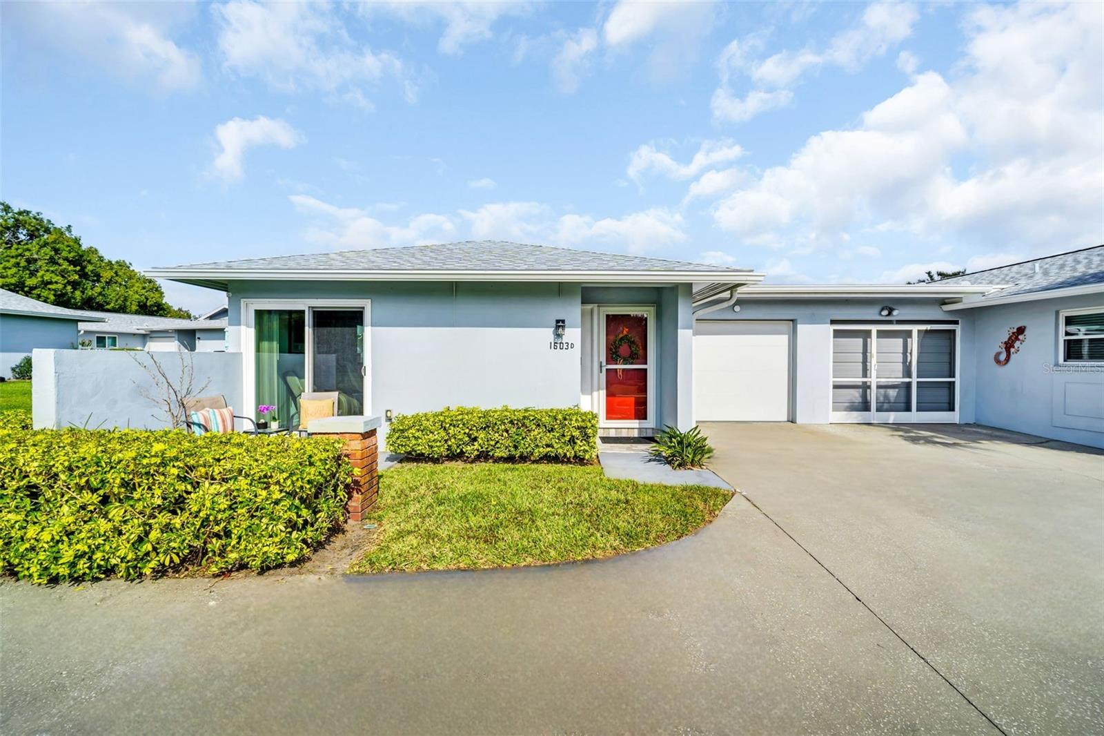 Beautifully renovated and spacious villa in Palm Harbor’s premier 55+ golf community, Highland Lakes, offering true maintenance-free Florida living. A thoughtfully designed floor plan lives large, enhanced by oversized hurricane-impact windows that flood the home with natural light. Enjoy smooth ceilings (no popcorn), recessed lighting, luxury vinyl plank flooring, and a fully updated kitchen and bath. The spacious living and dining areas are open and versatile. The efficient galley kitchen features wood shaker cabinetry, stone-look countertops, a closet pantry, raised tray ceiling, and newer appliances. The expansive primary bedroom impresses with TWO walk-in closets plus a dedicated dressing/vanity area. Hurricane-impact sliders lead to a private garden patio with privacy walls, while the sunny front patio sits just off the living room—perfect for relaxing or entertaining. Additional storage includes a foyer coat closet and hallway linen closet. The oversized, immaculate garage offers a climate-controlled space with an insulated hurricane-impact door, laundry station with utility sink, and abundant storage—providing flexible BONUS space not included in the square footage. Major improvements since 2017 include: new HVAC and water heater, hurricane-rated dual-pane windows and sliding doors, a fully renovated kitchen, and an updated bathroom with a walk-in shower, glass doors, new vanity, lighting, and fixtures. The reasonable monthly condo fee includes cable, internet, water, sewer, trash, lawn care, exterior pest control, insurance, and building & roof maintenance. Highland Lakes membership conveys with purchase, offering unlimited FREE golf on three private executive courses, tennis, pickleball, bocce, shuffleboard, an active clubhouse with fitness classes and entertainment, and a lakeside lodge on Lake Tarpon with private boat ramp, fishing pier, and community pontoon boats. Additional perks include RV or boat storage and a golf-cart-friendly neighborhood. Ideally located near award-winning beaches, shopping, dining, top medical facilities, sports venues, and international airports. Furniture is negotiable, making this home truly move-in ready and turn-key. If you love “new,” this one is for you—don’t wait!