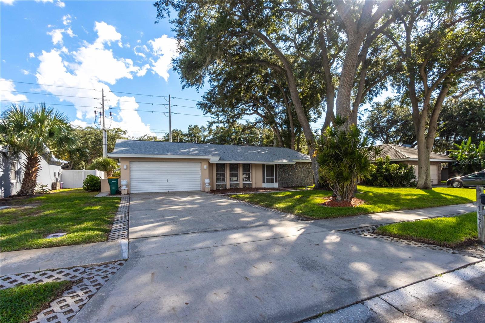 Discover the opportunity to make this 2-bedroom, 2-bath block and stucco home your own in the desirable Patty Ann Acres community of Palm Harbor. Offering solid construction and great bones, this home is ready for renovation and provides an excellent canvas for creating a home tailored to your style and needs. The galley-style kitchen features a convenient window overlooking the rear sunroom, while the inside laundry room adds everyday practicality. At the back of the home, the sunroom opens to a patio, creating a flexible space for relaxing, entertaining or enjoying Florida's year-round outdoor lifestyle.The location is a true highlight, with easy access to US 19 and Tampa Road making it convenient to travel throughout Palm Harbor, Dunedin, Clearwater and the greater Tampa Bay area. You'll be close to an abundance of shopping, dining, entertainment and everyday conveniences, while the area's beautiful Gulf beaches and waterfront destinations are just a short drive away. Nearby downtown Palm Harbor offers local restaurants, shops and community events, while Dunedin's charming downtown, waterfront parks and vibrant dining scene are also within easy reach. For outdoor enthusiasts, the area provides numerous parks, recreational facilities, trails and opportunities to enjoy Florida's natural beauty. Whether you're looking for a renovation project, an investment opportunity or a home in a centrally located Palm Harbor neighborhood, this property offers the location, layout and potential to create something special.