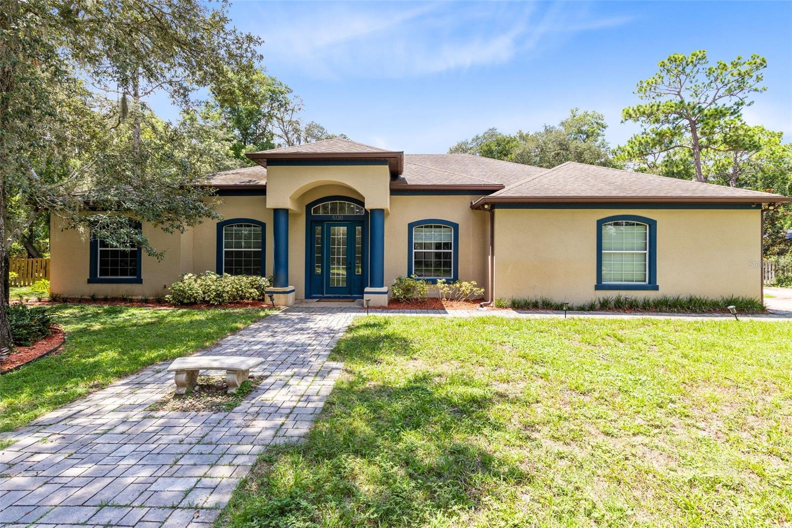 One or more photo(s) has been virtually staged. MULTIGENERATIONAL PROPERTY set on over 1/2 ACRE LOT with NO HOA!!! Beneath the shade of majestic oak trees, this 5-bedroom, 4-bathroom ONE STORY home combines classic charm with modern resort-style amenities. Step inside to find soaring 12-foot ceilings, expansive sunlit living spaces, and a split floor plan designed for both comfort and privacy.The primary suite feels like its own private sanctuary, complete with two walk-in closets, an oversized bedroom, and a spa-inspired bathroom featuring a jetted soaking tub and generous layout. Every bedroom offers 10-foot ceilings, creating a sense of openness throughout.Slide open the triple glass doors and step into your personal outdoor retreat: a screened-in patio spanning more than 400 sq. ft. with 12-foot ceilings, sparkling POOL & HOT TUB, and a fully equipped OUTDOOR KITCHEN with its own bathroom and shower—perfect for entertaining guests with ease.With NO HOA restrictions, you’ll have the freedom to enjoy this property however you wish. You can even convert the outdoor shed into an ADU or DETACHED MOTHER IN LAW SUITE! This home has endless opportunties to create a MULTIGENERATIONAL Property! Whether you’re sipping morning coffee under the oaks or hosting lively gatherings poolside, this home was built for both everyday comfort and memorable moments. All of this in a prime location close to shopping, dining, and TOP-RATED SCHOOLS! This home won't last long- schedule your showing today!