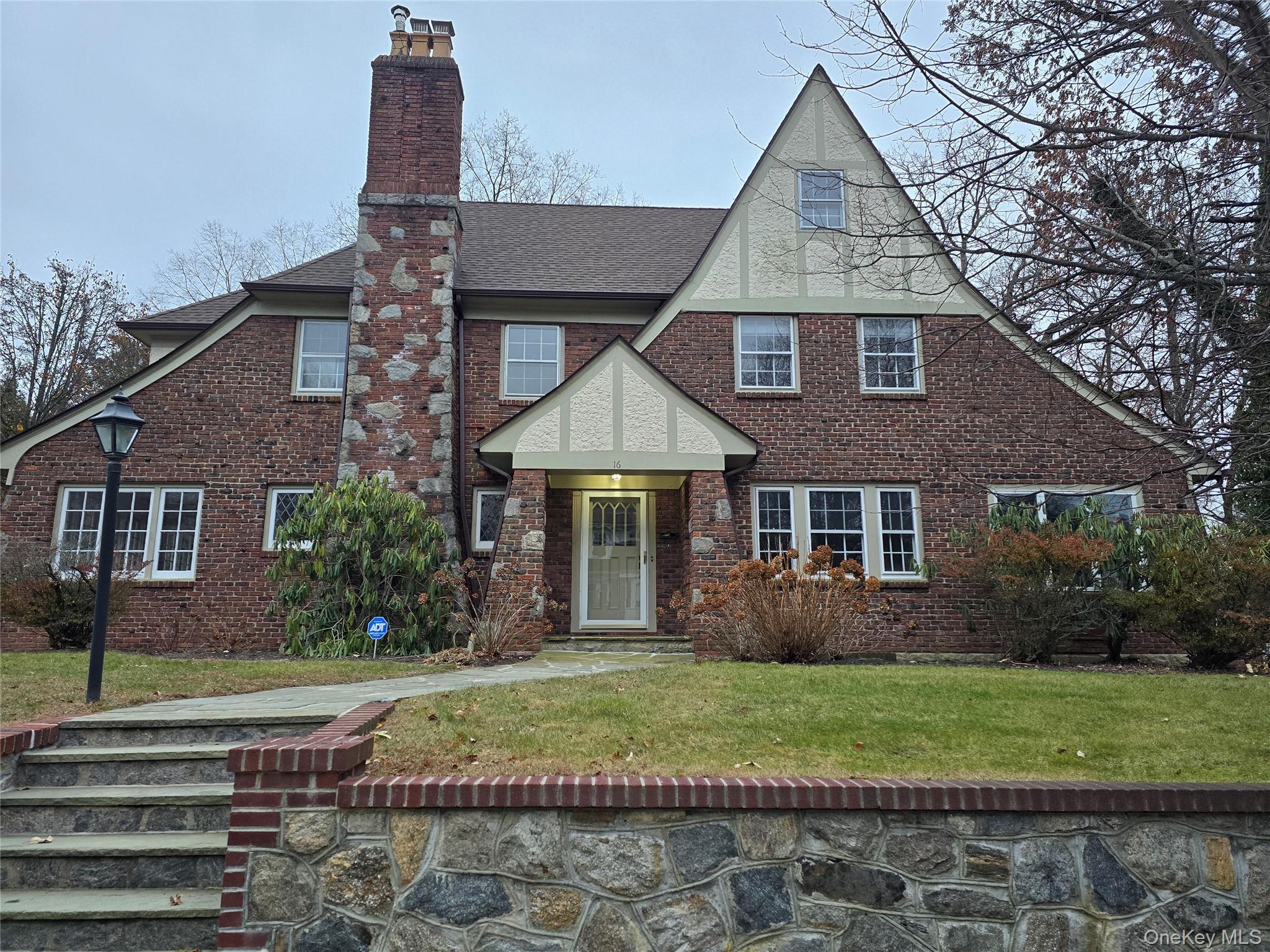 This jewel shines brightly.  Light, large, lovely & available for rent.  Prime location.  With a beautiful center hall entrance, this very large Tudor offers a living room with fireplace, family room with a wall of windows and door to patio to a spacious backyard. Large dining room, brick sunroom bright & inviting. Large eat-in kitchen, stainless steel appliances with views of the backyard. Large bedrooms have all walk-in closets, plus an extra room/office. The large master  bedroom have double closets plus an ensuite bath.  450 sq ft of bonus space in the basement. Close to schools, parks, shops, houses of worship & transportation. An application, along with financial documentation, credit & background check are required.