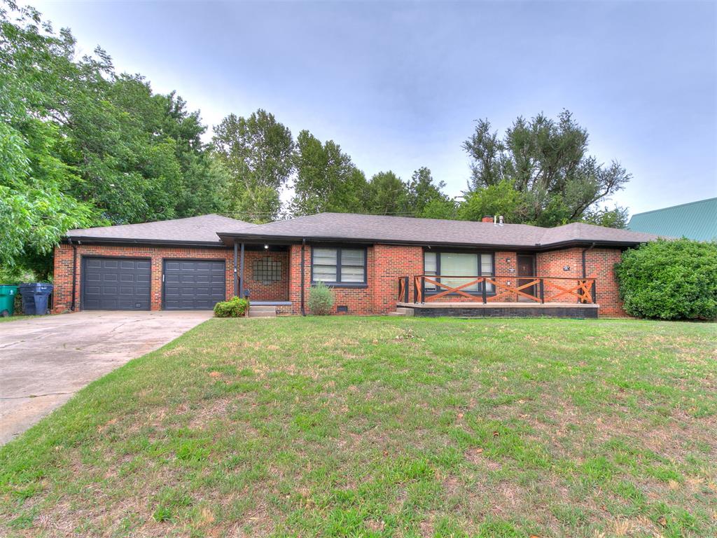 Priced well below value and ready to sell. This 4 bed, 3 bath brick ranch sits on a .344 acre treed lot in Linwood Place, just west of the Plaza District. A private wing with its own living area, bedroom, full bath, and separate exit to the backyard works for in-laws, adult kids, long term guests, or a home office. The main part of the house has hardwood floors, exposed wood beams, and a wall of windows in the living room. The kitchen has white shaker cabinets, granite counters, subway tile, stainless appliances with a gas range, and an island, plus a separate dining room. The primary suite has its own bath and walk-in closet, and two more bedrooms share a full bath. Out back, a deck runs the width of the house over a deep, shaded yard. Minutes to I-44 and Will Rogers Gardens. Vacant and easy to show. Bring your buyers. Three photos are digitally altered to show renovation potential with new paint, light fixtures, windows, a fireplace and furniture. The home is vacant. Unaltered photos of each room are included.