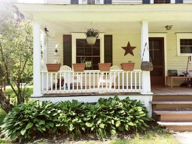 Doorway to property with covered porch