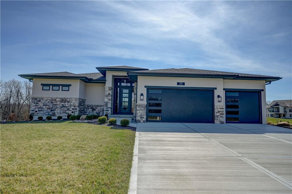 Discover elevated living in The Heather floorplan by Walker Custom Homes – a thoughtfully designed reverse 1.5 story home offering 4 bedrooms, 4 bathrooms, and 3,395 square feet of refined living space. This second tier lot backs to lush HOA greenspace, making your backyard a serene retreat, and comes with a private boat slip at the community docks, allowing you to embrace lake life with ease. This spacious layout features a large primary suite on the main level, complete with easy access to a stunning covered deck with an outdoor fireplace, perfect for year-round enjoyment. The open-concept main floor is ideal for hosting or relaxing in comfort, while the lower level includes a stylish bar and additional bedrooms, creating a versatile space for entertaining and guests. A true custom home experience! Nestled in the vibrant Lake Winnebago community, enjoy exclusive amenities including boating, fishing, scenic walking trails, horse stables, tennis and basketball courts, plus a brand-new community pool coming soon.