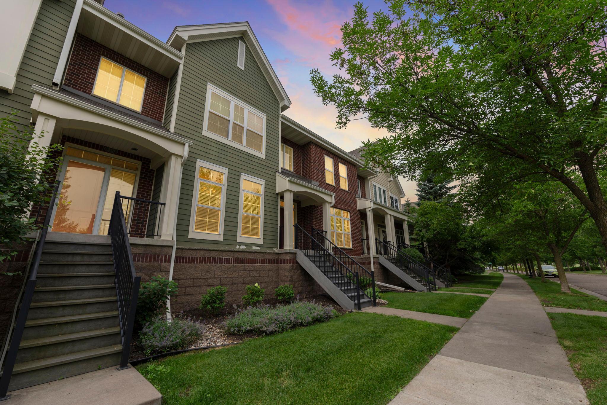 This stunning 2-bedroom, 3-bathroom townhome features numerous updates and desirable features, offering a low-maintenance lifestyle with exterior maintenance, lawn care, and snow removal included. Located in the sought-after Bridges at Arbor Lakes community in Maple Grove, you'll enjoy close proximity to shopping, dining, major highways, parks, and scenic walking trails.

The kitchen is a dream, featuring rich wood cabinetry, gleaming hardwood floors, stainless steel appliances, and granite countertops—including a spacious center island with breakfast bar seating, highlighted by elegant pendant and recessed lighting. Just off the kitchen, the generous dining room boasts 9-foot ceilings, a classic chandelier, hardwood flooring, and large front-facing windows that fill the space with natural light.

The main-level living room offers a warm and inviting atmosphere with a cozy gas fireplace framed by a stylish tile surround and built-in shelving—ideal for storage or showcasing decor. Beautiful hardwood flooring extends throughout the space, which opens to a spacious 21x6 maintenance-free deck—perfect for entertaining or simply relaxing and soaking up the sun.

Upstairs, you'll find a spacious and versatile loft—perfect for a home office, cozy sitting area, or additional living space. This carpeted area features a large rear-facing window that fills the space with natural light, along with a convenient laundry closet equipped with front-loading LG washer and dryer.

The upper-level primary bedroom features soft carpeting, a spacious 7x4 walk-in closet, and an additional linen closet for ample storage. Enjoy the comfort of a private ¾ en-suite bathroom complete with a walk-in shower, single vanity with granite countertops, and tile flooring.

The second upper-level bedroom offers cozy carpeting and generous closet space, and is conveniently located just steps from a full bathroom featuring a tub and shower combo, tile flooring, and a single vanity with granite countertops. 

The lower level offers a spacious bonus room—ideal for a home gym, office, or additional living space—featuring tile flooring, a closet for extra storage, and direct access to the attached two-car garage.

Additional notable updates include a new water heater (December 2025), garage door opener system (September 2023), New A/C (September 2023), new refrigerator (May 2024), new washer and dryer (May 2024), updated walk-in shower in the primary bathroom (April 2023), and fresh paint in all bathrooms (April 2023). Don’t miss the opportunity to own this beautifully updated townhome in a prime location!