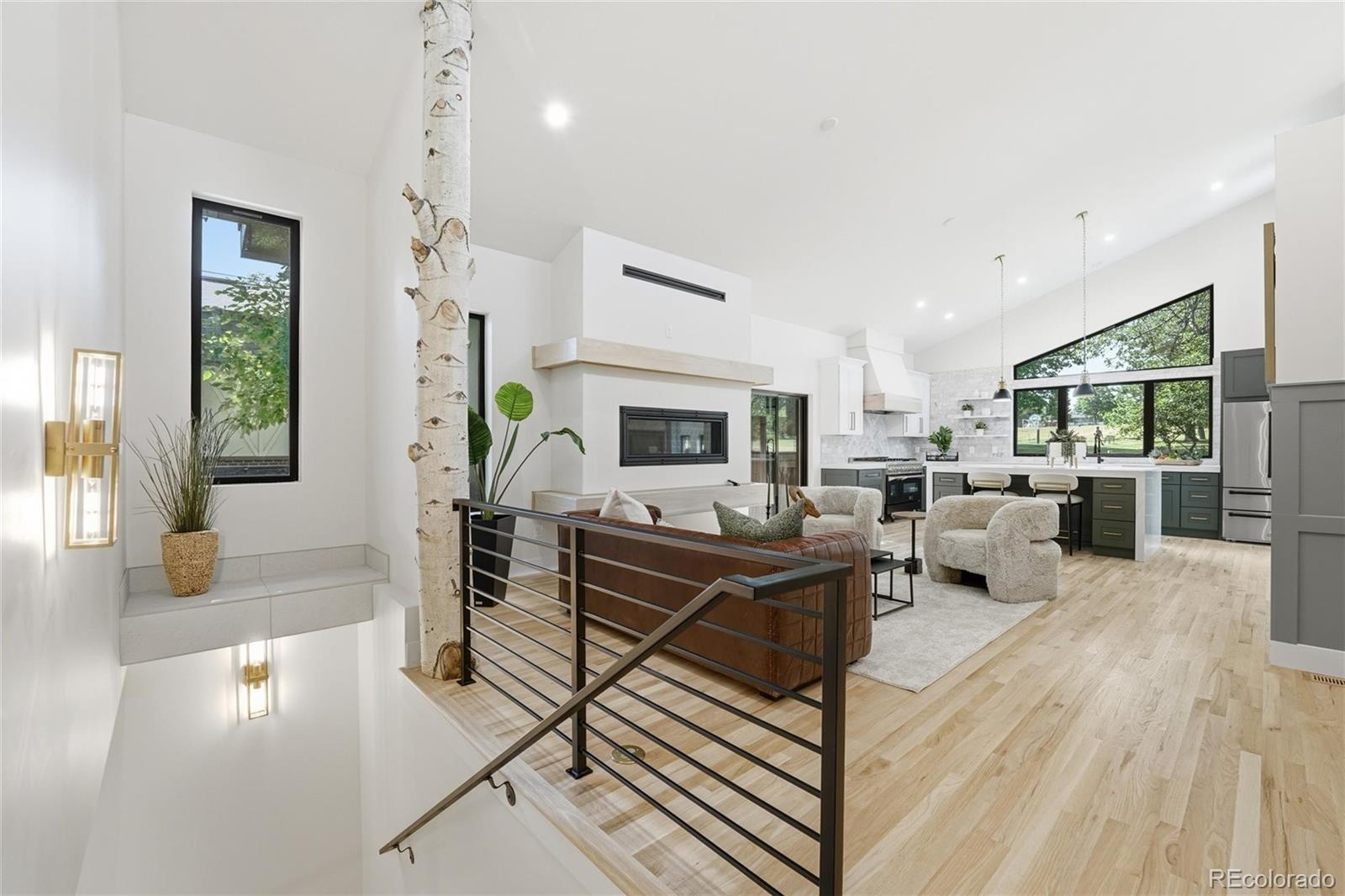 Rarely does a true ranch-style home of this scale and quality become available. Thoughtfully expanded and completely remodeled with full permits, this exceptional residence offers approximately 4,070 square feet of living space on a generous 10,529 sq ft lot directly across from Panorama Park.The builder carefully preserved the 1950s charm of the original home while maximizing the ranch potential of the large, open lot and protecting the mature trees for a truly custom result. The standout addition features a bright, open-concept kitchen designed for both everyday living and effortless entertaining, filled with natural light throughout the day. Every detail of the remodel was professionally executed and fully permitted, resulting in a move-in ready home that feels fresh and current.  The main level offers three bedrooms, each with its own private 3/4 or full bath, plus a fun powder room conveniently located near the main entrance. A south-facing sunroom provides the perfect morning retreat, while two fireplaces add warmth and character throughout the home.  Downstairs, a tucked-away bedroom with its own private bath and dedicated laundry creates a private lower-level suite with dual access. This flexible space is ideal for guests or offers excellent income potential if rented on Airbnb.  Outside, the brand-new poured driveway leads to an oversized 35' x 24' garage with ample room for vehicles, storage, and RV parking. The fully landscaped grounds include custom garden beds with drip irrigation, creating a low-maintenance, polished outdoor environment.  This is a rare opportunity to own a spacious, well-appointed ranch home in a desirable location with modern updates, thoughtful functionality, and strong income potential