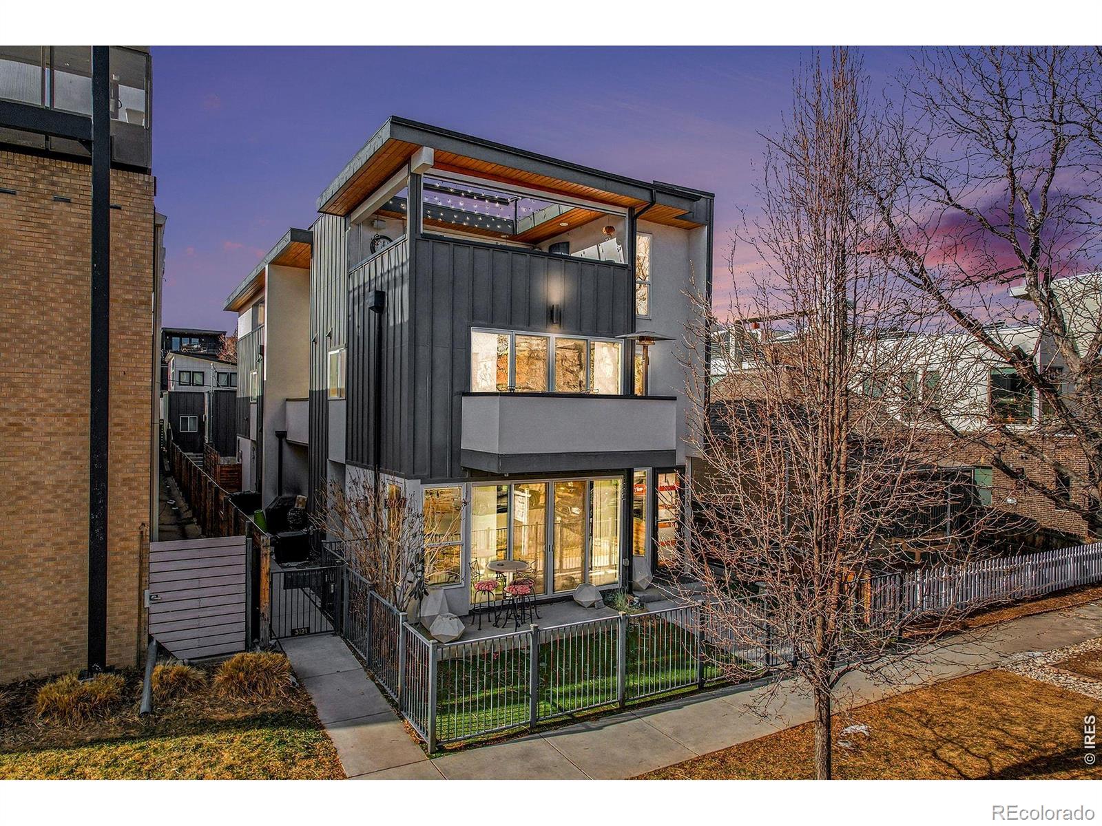 Experience Modern Luxury Living in the Heart of LoHi Welcome to this exceptional 4-bedroom, 5-bath modern duplex, perfectly situated in Denver's sought-after Lower Highlands. Built in 2017, this home seamlessly blends sophisticated design with everyday comfort, offering views of downtown Denver from a one-of-a-kind third-story entertainment suite. The 3rd open-air deck is an entertainer's dream, featuring a large fire pit, wet bar, & expansive indoor/outdoor seating. Enjoy city & mountain views through oversized sliding glass doors, or host unforgettable gatherings under the stars. The adjoining suite offers flexible space for a home gym, office, or guest bedroom with a full bath. Step inside to discover imported designer tile, gleaming hardwood floors, floating staircases, and 2 modern gas fireplaces The gourmet kitchen is equipped with a premium Jenn-Air appliance package, perfect for culinary enthusiasts. Each bedroom is generously sized, including a luxurious primary suite with a spa-inspired 5-piece bath and soaking tub. The fully finished basement features a private guest suite with a full bath and recreation area-ideal for visitors or family. The front yard is enclosed with a stylish wrought iron fence and features low-maintenance astroturf-perfect for pets or relaxing with neighbors in this vibrant, walkable community. Enjoy whole-home audio, smart thermostats, and remote access to security and climate controls-all easily managed from your phone or tablet for ultimate convenience and peace of mind. The original owners have enhanced the home with upscale touches, including remote-controlled blackout blinds, designer lighting, and retractable screens and awnings for added privacy and comfort on the third-floor deck. [See list for additional upgrades.] Step outside your door to explore LoHi's best restaurants, cafes, and nightlife-all just moments away. You'll love the vibrant energy and convenience of this trendy neighborhood