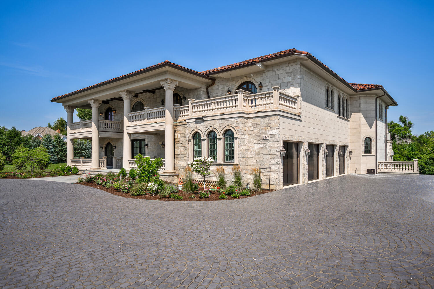 Welcome to 6413 County Line Road-an extraordinary new construction estate set on a full acre along Burr Ridge's prestigious Millionaires Row feeding into Hinsdale Central High School. Masterfully designed with timeless architecture and best-in-class finishes, this home offers a rare blend of luxury, comfort, and craftsmanship. The exterior makes an immediate statement, wrapped entirely in natural stone and limestone with a terracotta clay tile roof and Marvin windows throughout. Natural cobblestone pavers lead to a grand entrance framed by bluestone steps and manicured landscaping. Inside, you're welcomed by radiant-heated white Thassos marble floors with black inlays, soaring ceilings, and exquisite millwork throughout. The chef's kitchen is outfitted with Sub-Zero, Wolf, Thermador, and Bosch appliances, marble countertops with full slab backsplash, and custom cabinetry in a mix of painted, glazed, and stained finishes. A second full kitchen on the lower level adds exceptional functionality. Each bedroom is a private suite with its own balcony, while the primary bathrooms are outfitted in floor-to-ceiling marble with digital Kohler and Grohe fixtures and radiant heat. Throughout the home, 5" white oak flooring adds warmth, and four custom staircases with hand-forged wrought iron offer both elegance and flow. The lower level is designed for entertaining and wellness, featuring a full bar, state-of-the-art theater, sauna, steam room, and a custom three-level elevator.  Located near top-rated schools, country clubs, Hinsdale Hospital, and just minutes from downtown Hinsdale and Burr Ridge, this home delivers unmatched quality in one of Chicagoland's most coveted locations.