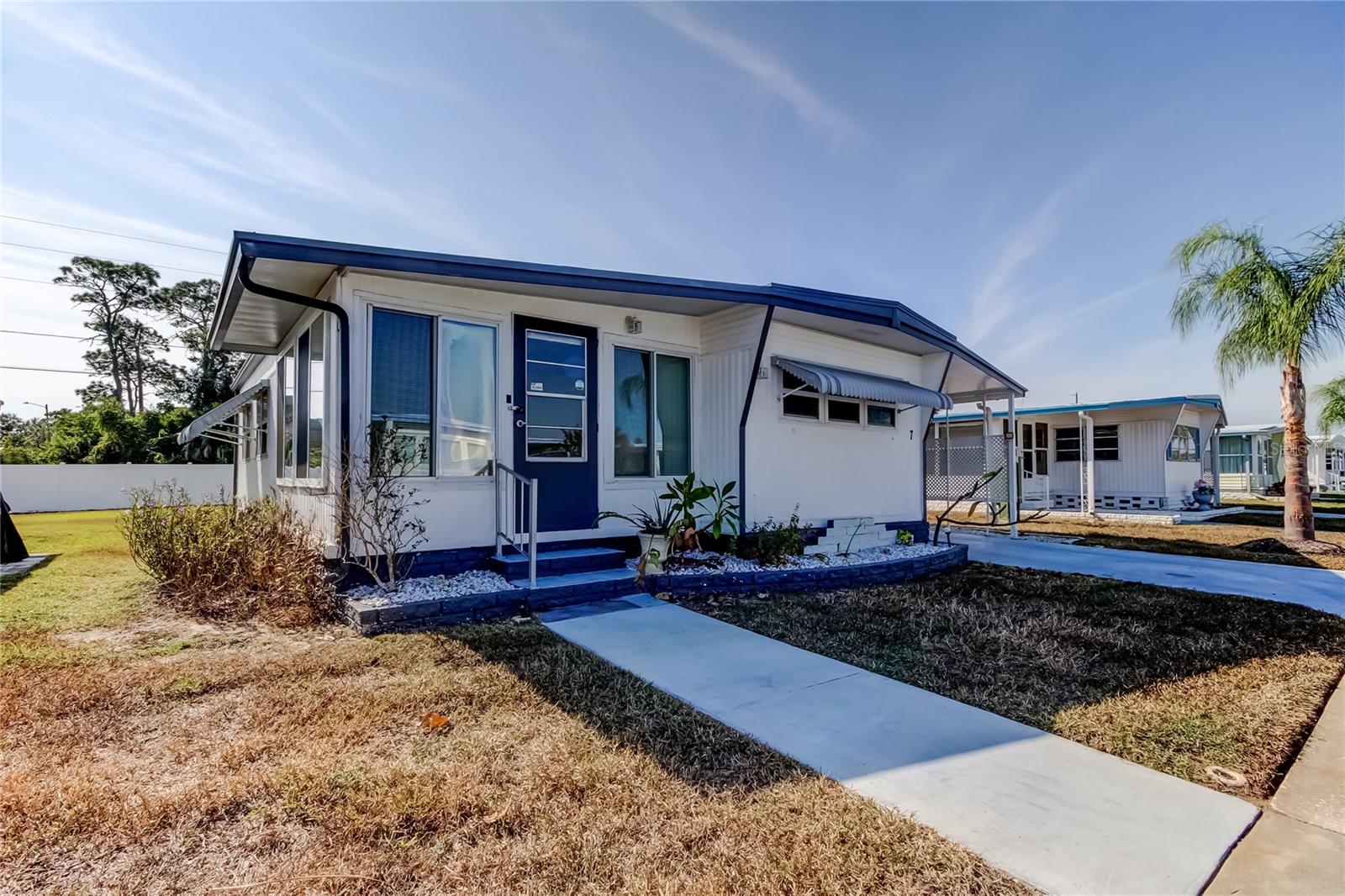 Discover Your Slice of the Sunshine State Paradise in the Highly Sought-After, Conveniently Located, Land-Owned 55+ Community of Tarpon Shores! This Budget Friendly 2-Bedroom, 2-Bath Home Offers a True Maintenance-Free Lifestyle! PLEASE NOTE: the $40K Land Share Is Already Included in the List Price (it can be financed thru the HOA).  Step Inside to Find a Beautifully Updated Kitchen, Low-Maintenance Wood-Grain Laminate Flooring, and a Bright, Enclosed 12x12 Florida Room That Adds a Generous 144 Sq Ft of Usable Interior Space. Peace of Mind Comes w/ Major Updates, Including A Durable 30-Year METAL ROOF (2010), 2015 HVAC System, 2023 WATER HEATER, Plus Updated Double-Pane Thermal Windows Throughout, & BOTH a “Salt” Water Softener and Water Purification System. Outdoors, Enjoy Exceptional Privacy in Your Spacious Backyard with No Rear Neighbors, Secured By 6’ White Vinyl Fencing that Surrounds the Perimeter of the Community! Take Advantage of Two Oversized Sheds (11x10’ & 11x14’), One Featuring a Dedicated Laundry Space with Extensive Built-In Storage – the Second is Up for Anything Your Heart Desires! Gardening? Meditation Room? Home Gym? Art Studio? Use it for Your Preferred Purpose! There is a Vanity in this Space, for Your Convenience! The Possibilities are Endless! For Only $315/Month, a Low HOA Fee, Covers an Incredible Package: Water, Sewer, Trash, Cable TV, Wi-Fi/Internet, Mgmt, Full Lawn Care, Giving You More Time to Enjoy the Resort-Style Amenities:  Like a Heated Pool, Clubhouse, BBQ Grills, Kitchen, Billiard Room, Shuffleboard Courts, Fitness Center, Library, Shuffleboard or Bocce Ball – with a Long List of Community Activities to Make New Friends in Your Full Time or Part Time New Home!! Located In the Most Preferred Flood Zone 'X' …  Minutes From Golf, Boating, Shopping, Lifestyle Amenities, Tarpon Springs, Palm Harbor, or Dunedin Downtown Areas… Where you Can Witness Stunning Sunsets, This Property is a Fantastic, Turnkey Opportunity for Affordable Active Florida Living. All Appliances, Including Washer/Dryer, Convey w/Purchase! Tarpon Shores is a No Pet Community, Unless Appropriate Documentation is Provided for Service/Therapy/Emotional Support Designations. Come Have a Look! We’re Serious About Selling.. If you’re Serious About Buying! Leasing is Allowed After 2yrs of Ownership; Restrictions Apply. Just Ask, I’m Happy to Provide the Community Rules/Regs, Brochure, etc..