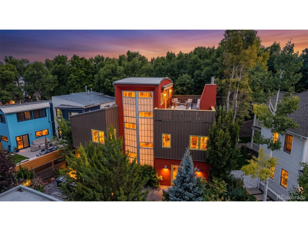 Designed for those who appreciate exceptional architecture, thoughtful design & creative living, this remarkable residence is tucked into one of the quietest pockets of Prospect New Town, Longmont's iconic urban village known for its award-winning architecture, boutique shops, artisan coffee, local dining, parks & walkable streets. Surrounded by mature trees, no neighbors behind, a peaceful setting offering rare privacy, private alley & a detached oversized 3-car garage. Every space was designed with purpose where industrial influences, contemporary finishes & artistic character come together effortlessly. Entertain from the rooftop terrace, host unforgettable evenings around the custom indoor bar or escape to the courtyard featuring a tranquil waterfall pond, mature landscaping & ample seating areas. Above the garage, sits the 1 Bed / 1 Bath (576 Addtl. Sqft) Carriage House featuring its own entrance, kitchen, living area & laundry, offering outstanding flexibility for multi-generational living, private guest accommodations or valuable short/long-term rental income. Three exclusive parking spaces beside the garage make guest access effortless. The primary suite offers a peaceful retreat with a fireplace, spa-inspired bathroom featuring steam shower jets, dual vanities & expansive dual walk-in closets. The spacious secondary bedrooms are filled with natural light while the inviting front porch offers the perfect place to begin or end each day. The finished basement even functions as a private guest suite with living area, kitchenette, bedroom & bathroom. Some homes are built to fit in, this was designed to stand apart. With its rare blend of architectural creativity, functional flexibility, income-producing potential & an unmatched location within Prospect New Town, this is a place where neighbors become friends, community comes naturally & every day is enriched by the beauty that surrounds you. You'll regret not seeing this one! Schedule your private tour today!