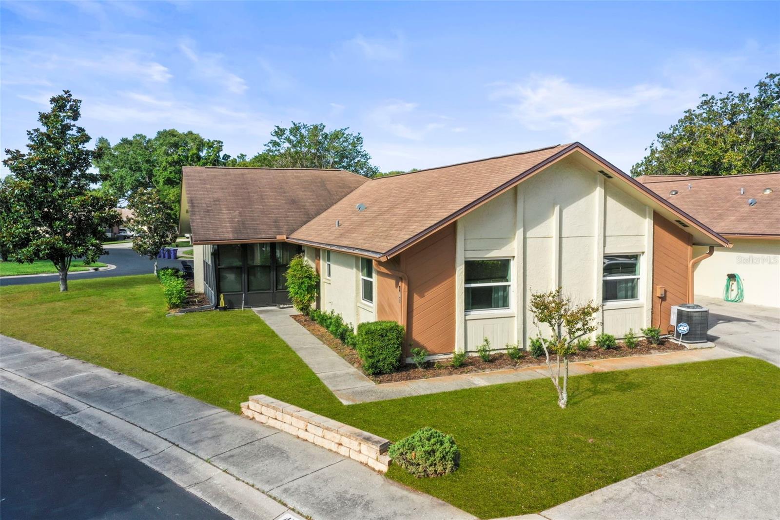 A WONDERFUL GOLF CART FRIENDLY DUNEDIN LOCATION! This beautifully maintained 2-bedroom, 2 bath villa offers the perfect blend of comfort, convenience, and Florida charm. Nestled in a peaceful 55+ community, that is not in a flood zone.  This spacious villa features an open layout, an attached garage with driveway off street parking and located across from the pool. You’ll love the resort style amenities just steps from your door—two sparkling community pools (one heated), tennis courts, shuffleboard, and a fully equipped recreation center that hosts year-round activities and social events. Lush landscaping and mature oak trees line the neighborhood, creating a serene, park like setting.One of the community pools sits just across the street, making it easy to enjoy a morning swim or relax with neighbors. Inside, the bright enclosed lanai welcomes the morning sun through its wall of windows, offering a perfect spot for a reading nook, office, or cozy sitting area. This immaculate home was thoughtfully updated in 2016 and has been exceptionally cared for. The bright and sunny enclosed lanai (additional 150 sq ft)  is an ideal spot for an office, sitting room, library or extra space for guests. HOA covers water, Sewer, trash as well as building maintenance.Just two blocks away, you’ll find a scenic park with a 1 mile paved walking loop, pond views, picnic areas, and a playground. And of course, you’re only minutes from vibrant downtown Dunedin, known for its weekend farmers market, boutique shops, waterfront sunsets, and an incredible selection of restaurants and breweriesThis villa offers the ideal Florida lifestyle—low maintenance living in a friendly, active community close to everything that makes Dunedin so special.