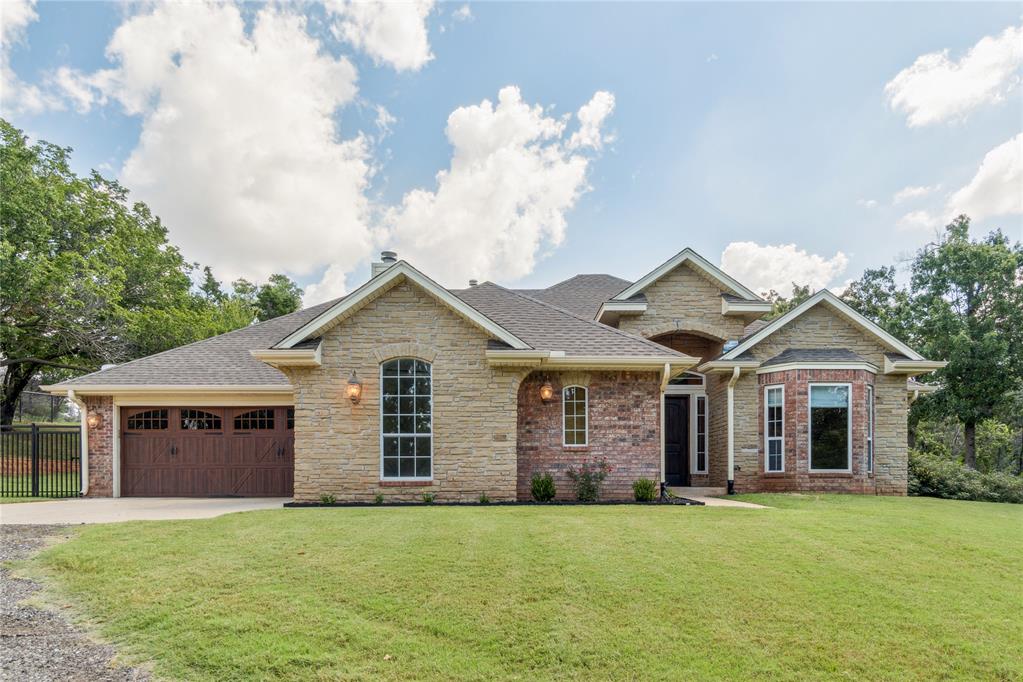Set on 4.7 beautifully landscaped acres, this custom-built estate combines timeless design with modern convenience. A double-gated entry—one keypad, one key-card—welcomes you into a property that is fully fenced and sectioned with iron gates for privacy and security. Inside, the home features stone tiles and wood flooring, 10-foot ceilings with crown molding, and elegant accent columns. A private office with French doors, full mudroom with wash bin, and cabinetry throughout provide both style and function.

The living room features a wood-burning fireplace with custom mantle and built-in electronics cabinet space, while unique chandeliers in the entryway and remote-control ceiling fans add to the home’s refined details.

The kitchen is a true highlight, offering all-chrome Samsung appliances, a five-burner gas stove with microwave electric oven, dishwasher, garbage disposal, granite countertops, tile backsplash, and ceiling-height cabinetry with breakfast bar. The adjoining dining area, canned lighting, and pendant fixtures create the perfect space for entertainment.


The primary suite includes an elevated ceiling, custom sliding barn doors, dual walk-in closets with built-ins, and a spa-like bath with double vanities, private toilet room, oversized walk-in shower, and a large soaking tub. Three guest bedrooms each include fans and bay security windows, with walk-in closets in two rooms. The main guest bath offers dual sinks, private tub/toilet area, and extra cabinetry. A granite powder bath is perfect for visitors.

Additional features include large 3-car garage, garage flooring is sealed & textured with an attic lift, Kohler backup generator, gated back patio and gas hot tub, and alarm system for peace of mind! This property blends luxury finishes with everyday practicality—an exceptional opportunity to own a move-in ready estate on nearly 5 acres.