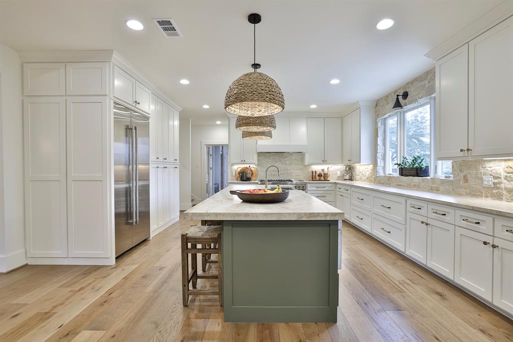 Exceptional French-inspired home with a modern flair, located in the 24-hour gated golf course community of Mira Vista. Stunning remodel in 2020 with one of a kind architectural features and details. The open-concept kitchen, living, and dining spaces provide a seamless flow for both everyday living and grand entertaining. An elegant office, chic wet bar, and cozy den offer versatile spaces, while the LUX magazine-featured kitchen is a chef’s dream—complete with top-tier appliances and custom finishes that elevate the home’s aesthetic. The main floor is home to the primary suite with a private sitting area, dedicated office, large sized closets, custom marble bath with dual vanities, a freestanding tub, and glass shower. An additional guest suite and expansive laundry-mudroom complete the main level, providing ample space and functionality. Upstairs, you'll find four spacious bedrooms, two full bathrooms, an exercise room, and a media room with a bar area. What was once a three-car garage has been transformed into a sensational game room with dual HVAC units, a wet bar, and a convenient half bath. Glass doors open up to a stunning outdoor oasis, where a newly constructed pool with waterfalls and an attached spa create a resort-like atmosphere. A covered pergola adds charm and shade, making this space perfect for relaxation or hosting guests. Every corner of this home exudes sophistication, craftsmanship, and thoughtful design, offering a rare opportunity to experience luxury in one of the area’s most sought-after communities.