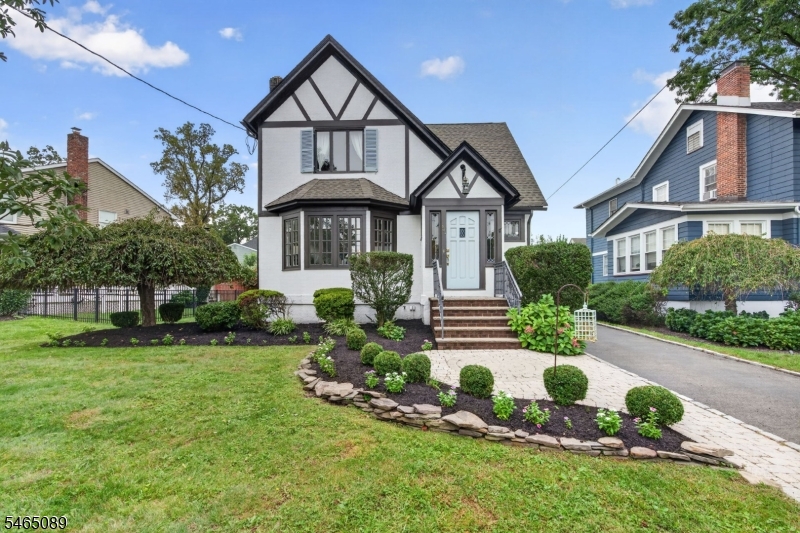 Some houses have a way of making you feel at home before you even walk through the door. Set on one of Cranfords most desirable, tree-lined streets and just a short block from Nomahegan Park, this beautiful Tudor offers the character, warmth and sense of place that you will only find in these classic homes. Its distinctive architecture creates an inviting first impression, while the interior offers spaces designed for both everyday living and making memories. Inside, you will find a spacious easy flowing first floor perfect for entertaining. Upstairs, you will find three sizable bedrooms, a bonus room and full bath with heated flooring. Adding to the appeal is a detached two-car garage with a finished second floor that provides a flexible space ready to become whatever life calls for. And the location makes it even more special. Enjoy easy access to beautiful walking paths, open spaces and recreational amenities, while remaining close to Cranfords charming downtown, restaurants, shops, schools, and community life. With its wood-burning fireplace, stained glass, versatile garage space and coveted location, this is a home with personality, warmth and a story waiting for its next chapter. Come see it, settle in, and imagine the memories you could make here. A home with a story, a neighborhood you'll be proud to call your own, and a location that makes everyday life feel a little more enjoyable. Come experience this Cranford Tudor and see why some houses simply feel like home.