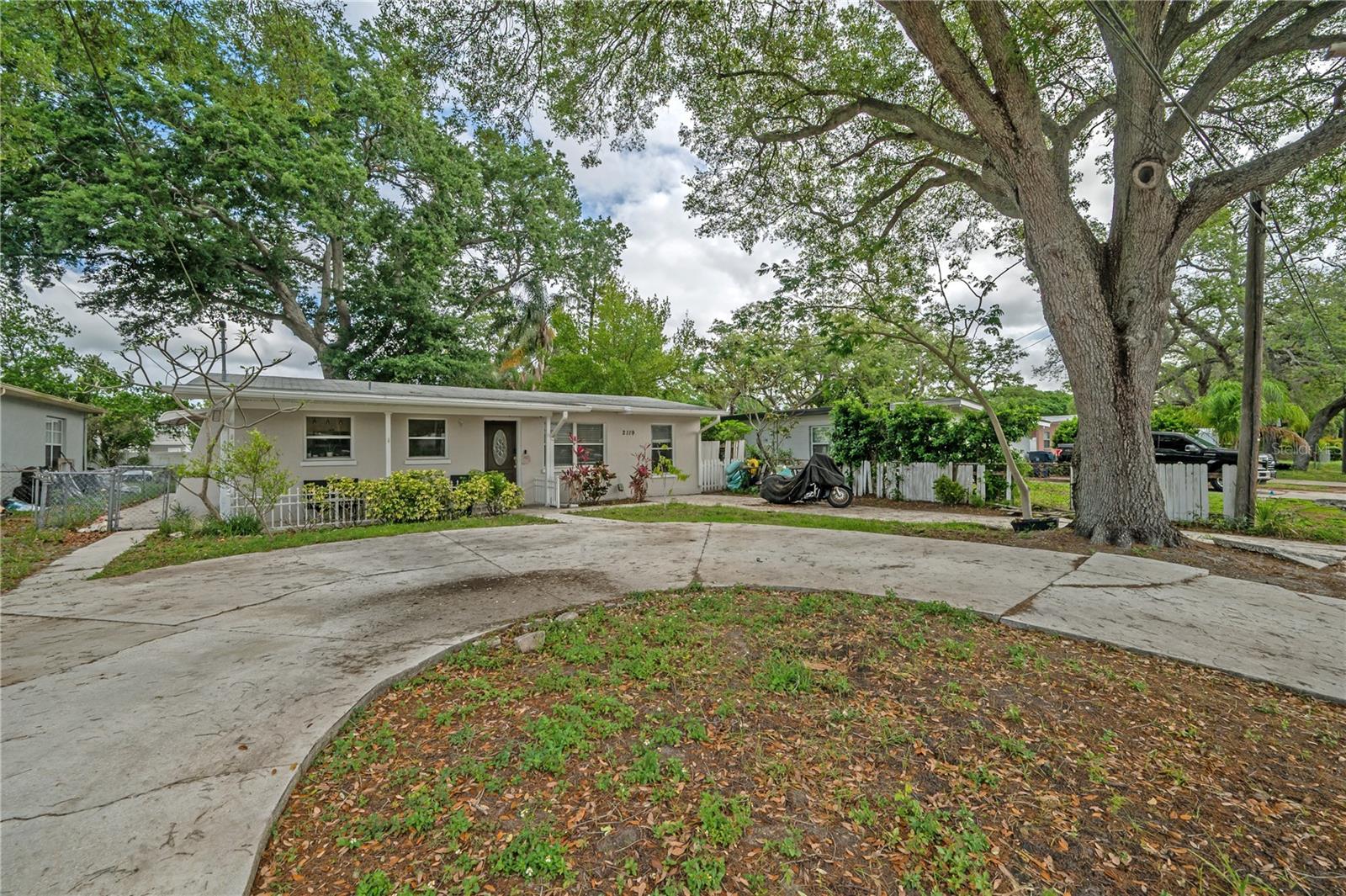 Charming 3-bedroom, 2-bath cottage located in the heart of Tampa, featuring a private screened-in swimming pool and a lush tropical garden setting. Inside, the unique and flexible floor plan allows for traditional 3 bedroom and 2 bathroom living. Two of the bedrooms are exceptionally spacious with sliding glass doors leading directly to the backyard and pool area. The kitchen is well-appointed with custom wood cabinetry, granite countertops, and stainless steel appliances. The primary suite features a large walk-in shower with a built-in tiled bench, while the guest bathroom showcases charming original pink tile, adding a touch of vintage character. Step outside to enjoy the expansive back patio complete with a fire pit perfect for entertaining, barbecues, or creating your dream outdoor kitchen. The screened-in pool provides year-round enjoyment. Additional highlights include a circular driveway for ample guest parking, plus a separate driveway with space for an RV, boat, or trailer. Conveniently located between Veterans Expressway and I-275, near Armenia and Hillsborough, and just minutes from Tampa’s riverfront expansion projects. This is a home you’ll truly love to call your own!