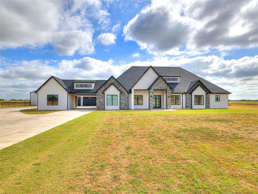 Modern Luxury on 10 Private Acres Stunning 4 bed, 4.1 bath custom home featuring a light-filled open layout and a show-stopping kitchen with oversized island and walk-in pantry. Thoughtfully designed with a private office, safe room, spacious laundry, and a luxurious primary suite with spa-like bath and massive closet.Enjoy outdoor living on the expansive covered patio overlooking your private acreage. Includes a 4-car garage and a 3,600 sq ft insulated shop with covered porch—perfect for hobbies, business, or storage.High-end finishes, space, and privacy—this one truly has it all.