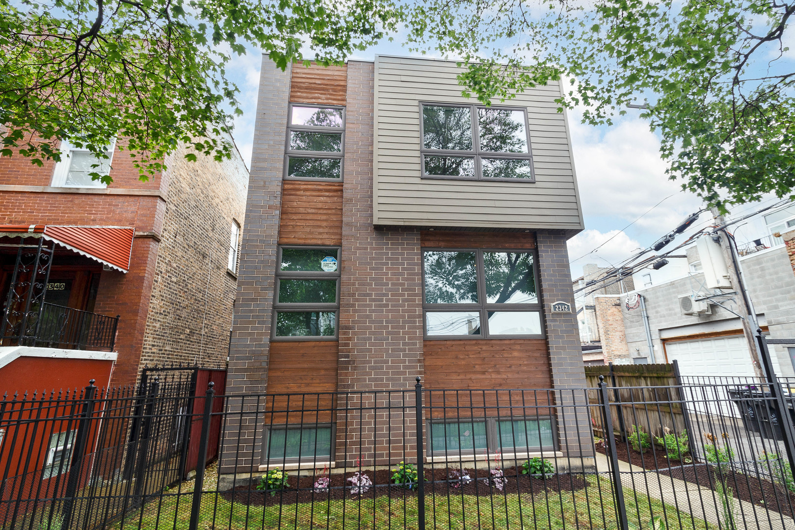 Bright and spacious 4 bed, 3.1 bath single family home on an extra-wide 30' lot in Logan Square! Contemporary facade, fenced in corner lot, and fresh landscaping. Expansive, open concept main level floor plan with hardwood flooring, great natural light, and on trend kitchen with white shaker cabinetry, quartz countertops, island with bar seating, and stainless Bosch appliances. Main level bedroom and full bath. Upper level primary suite with private bath featuring dual sinks and frameless glass shower + WIC with custom organizers. Two additional bedrooms, full bath, and laundry with washer/dryer complete the upper level. Finished lower level features new carpeting, nice ceiling heights, huge recreation room, half bath, utilities, and second laundry with washer/dryer. Fresh paint throughout! Enclosed backyard with large paver patio and detached two-car garage. Prime Logan Square location with easy access to all your favorite restaurants, shopping, night life, public transportation, and more. Just over 5 mins to the Healy metra!