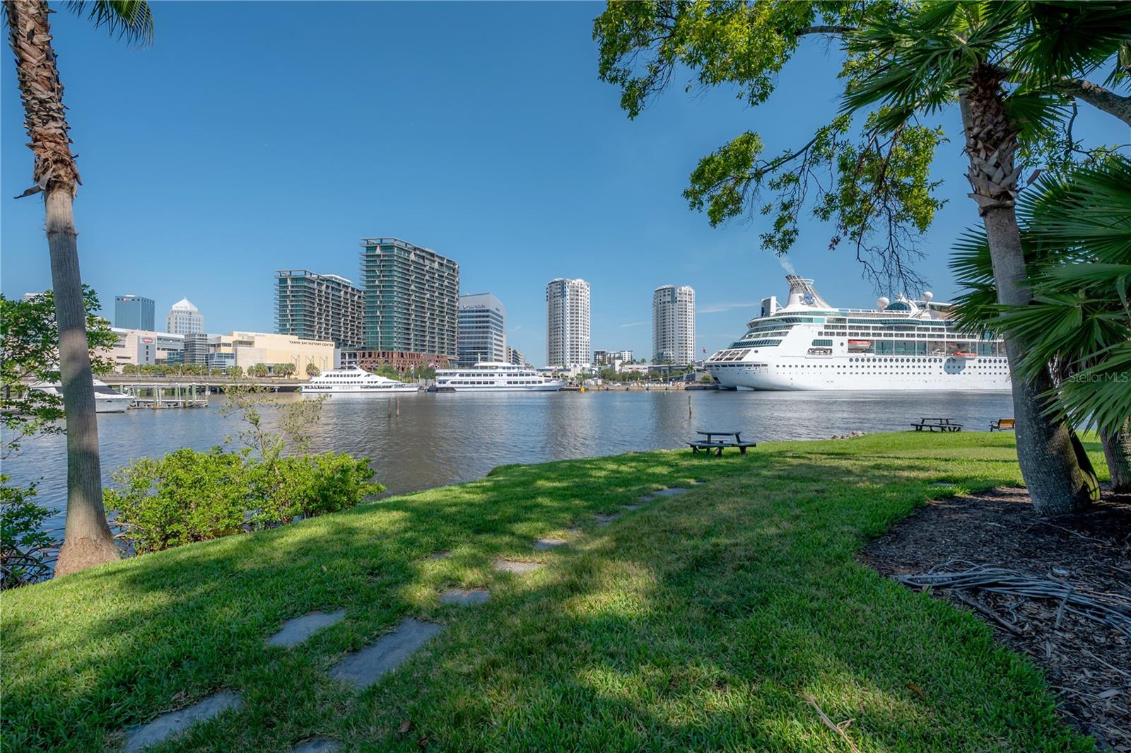 The ONLY one bedroom available in the community! Welcome to Island Place on Harbour Island—the unit with the best location, the garage, and the best floor plan! This beautifully updated condo offers the ultimate Harbour Island lifestyle with 1 spacious bedroom, an open den/office, and a split-level open layout filled with natural light—especially magical during golden hour. Step outside to your private balcony with views looking out onto the island, or head down to the headline-worthy oversized 2-car garage. Rare for the area, this garage can easily fit 2 SUVs, and still includes a bonus space (currently set up as the ultimate man cave with TV, outdoor fridge, and couch), room for outdoor toys like kayaks, paddle boards, bikes, motorcycles, PLUS two additional private parking spaces. Whether you’re watching the big game at home or walking just ¾ of a mile to catch the Lightning at The Bench Arena, you’re perfectly positioned for all of Tampa’s best sports and entertainment. Noteworthy features include new epoxy flooring in the garage, a new HVAC system, hot water heater, updated kitchen with on-trend wood cabinetry with glass fronts and under cabinet lighting, refrigerator, dishwasher, and dryer, fresh interior paint, new carpet in the bedroom, and warm-toned wood flooring throughout. Life at Island Place offers the best of both worlds with low-maintenance condo living while giving the feel and privacy of a single family home. The community offers 24-hour security (with easy QR code access for your guests), lush tropical grounds that are immaculately maintained, and walkable access to all the excitement of downtown Tampa. Enjoy resort-style amenities including two pools and spas, tennis courts, playground, outdoor grilling areas, pet walks, two fitness centers with views, and multiple waterfront viewing spots where you can launch a kayak or paddleboard. HOA fees also cover biweekly valet trash pickup, regular pest control, water, and even AC drain line cleanings. Living here means you’re just steps from it all—“The Bench” Arena for Lightning games and concerts, Jackson’s Bistro, American Social, Lifetime Fitness, Starbucks, Water Street, Sparkman Wharf, the Riverwalk, Florida Aquarium, museums, the Convention Center, parks, and trolley access to Ybor. Quick access to Tampa International Airport and major highways makes commuting seamless. Boaters can dock at one of two walkable marinas or join the Freedom Boat Club right on the island. This is your chance to own a piece of Harbour Island paradise with everything Tampa has to offer right at your doorstep. *Ask about preferred lender incentives!*