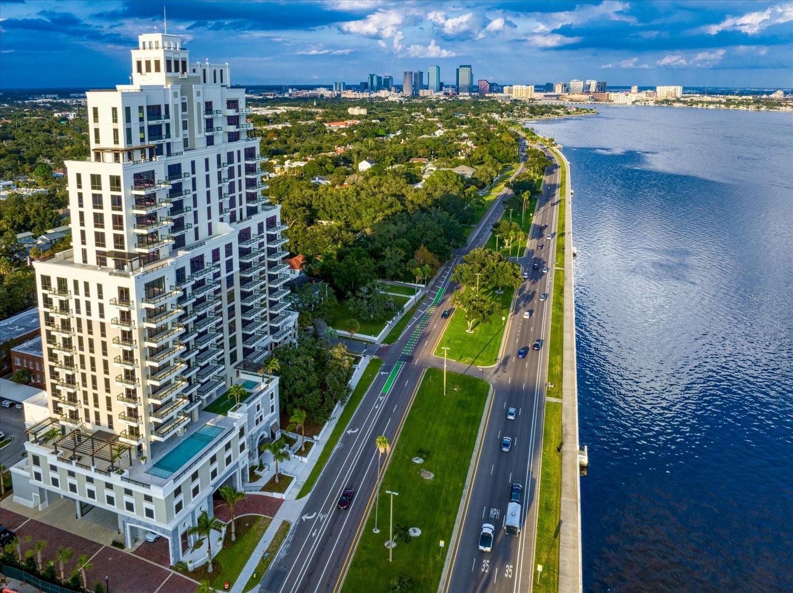 Discover an exceptional new standard of living at Hyde Park House, an elegant 22-story residential tower offering just 70 exclusive residences along iconic Bayshore Boulevard. Perfectly positioned in the heart of historic Hyde Park, The Chester residence spans over 2,000 square feet and is thoughtfully designed for both comfort and privacy. This split-bedroom floorplan features two spacious bedrooms, a versatile den, and three full bathrooms. The den is appointed with a built-in wall bed that effortlessly converts to a desk, making it ideal as either a guest room or a private home office. An oversized terrace extends your living space outdoors, with access from both the Great Room and Owner's Suite — ideal for enjoying the tree tops of Hyde Park. Interiors showcase high-end finishes throughout, including 10-foot ceilings, expansive layouts, and large-format porcelain tile flooring. The chef-inspired kitchen is appointed with European-style cabinetry, quartz countertops, premium Gaggenau appliances, gas cooktops, and an Electrolux front-load washer and dryer. HunterDouglas electronic remote-controlled blinds included throughout. Furniture is negotiable. The building features a whole-building water softener system, a hot water supply system and a central cooling infrastructure designed for efficiency and comfort. The residence is served by the building's condenser water loop, which circulates chilled water throughout the tower. Your individual AC unit is powered by electric fans, meaning your electric bill will reflect energy used while your AC is running — a straightforward and transparent utility structure that puts cooling costs directly in your control. Residents enjoy a curated collection of resort-style amenities on a beautifully landscaped waterfront plaza, including a pool and spa, outdoor summer kitchen with gas grill, fire pit, fitness center, and social lounge. The building also offers a secure private parking garage, access-controlled entry, climate-controlled storage, and 24-hour front desk attendant. Tampa International Airport is just 20 minutes away. With its rare blend of modern luxury and walkable access to Hyde Park's renowned shopping, dining, and nightlife, Hyde Park House is one of South Tampa's most prestigious residential addresses.