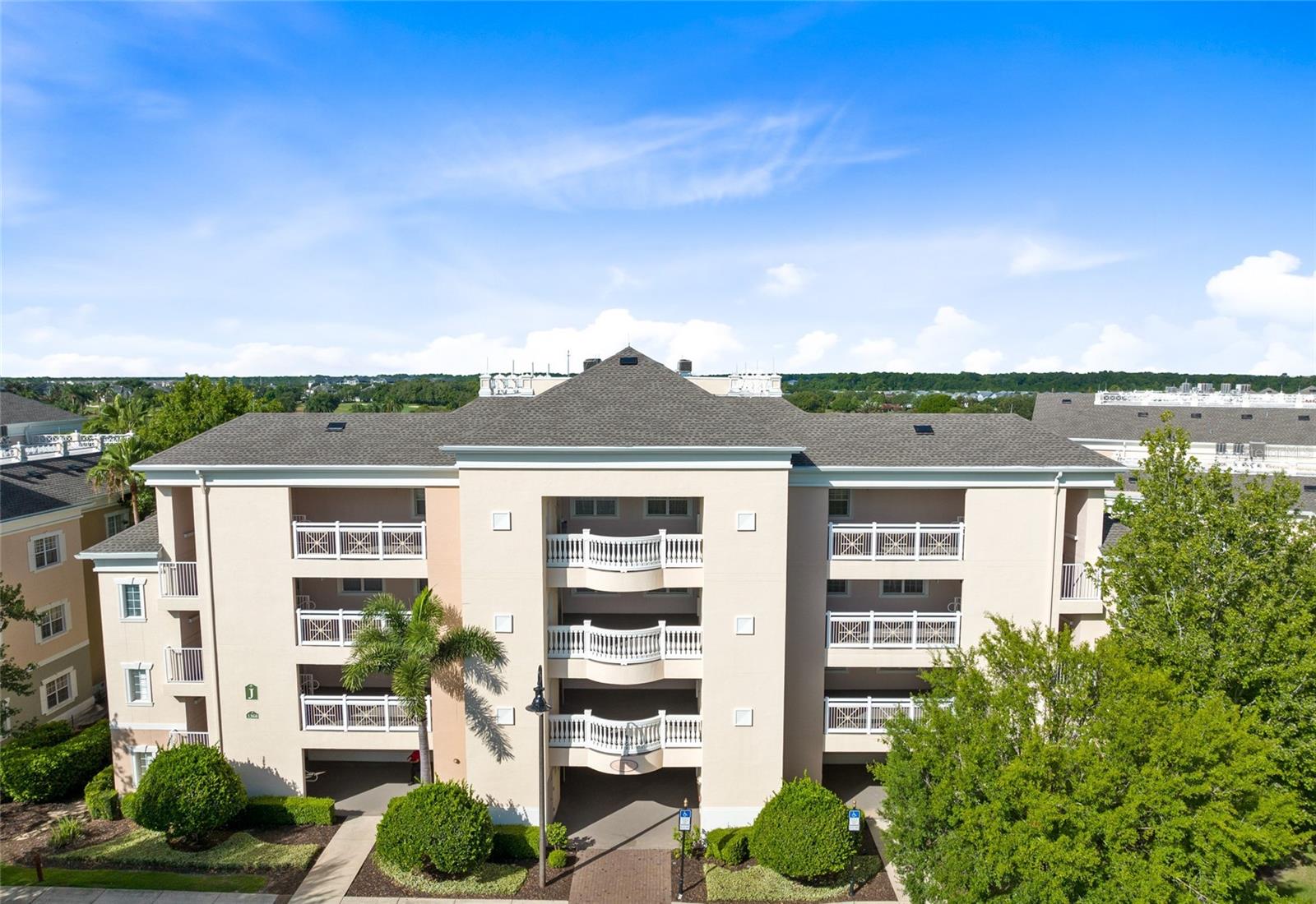 One of the best end-unit locations in Centre Court tucked away in a protected corner overlooking a garden area to the side and view of nothing but golf holes and sunsets from the bright and airy living room and open back patio. This condominium comes fully furnished with an inviting, sleek modern look in the furnishings, décor and fittings and offers stylish wood-look flooring in the living and dining area. and primary bedroom. On the ground floor, it is ideal for those that prefer not to deal with stairs or elevators, and for those needing more accessible accommodations, this condominium features some useful additions to the bath area to accommodate those with limited mobility. Standard in all Centre Court units are quality features such as fitted wood kitchen cabinets, stainless steel appliances, granite countertops, crown molding and tray ceilings. The end unit also has a handy outdoor storage closet ideal for golf clubs, bicycles and sports equipment, so they are ready and waiting for you on each visit to your personal Florida home. There is an active membership to the Reunion Club to give the option of full access to all Reunion's outstanding amenities, including the tennis and pickleball courts adjacent to this condominium, and the property has an excellent rental history with future bookings in place. Be sure to put this one at the top of your list, as it will not last long.
