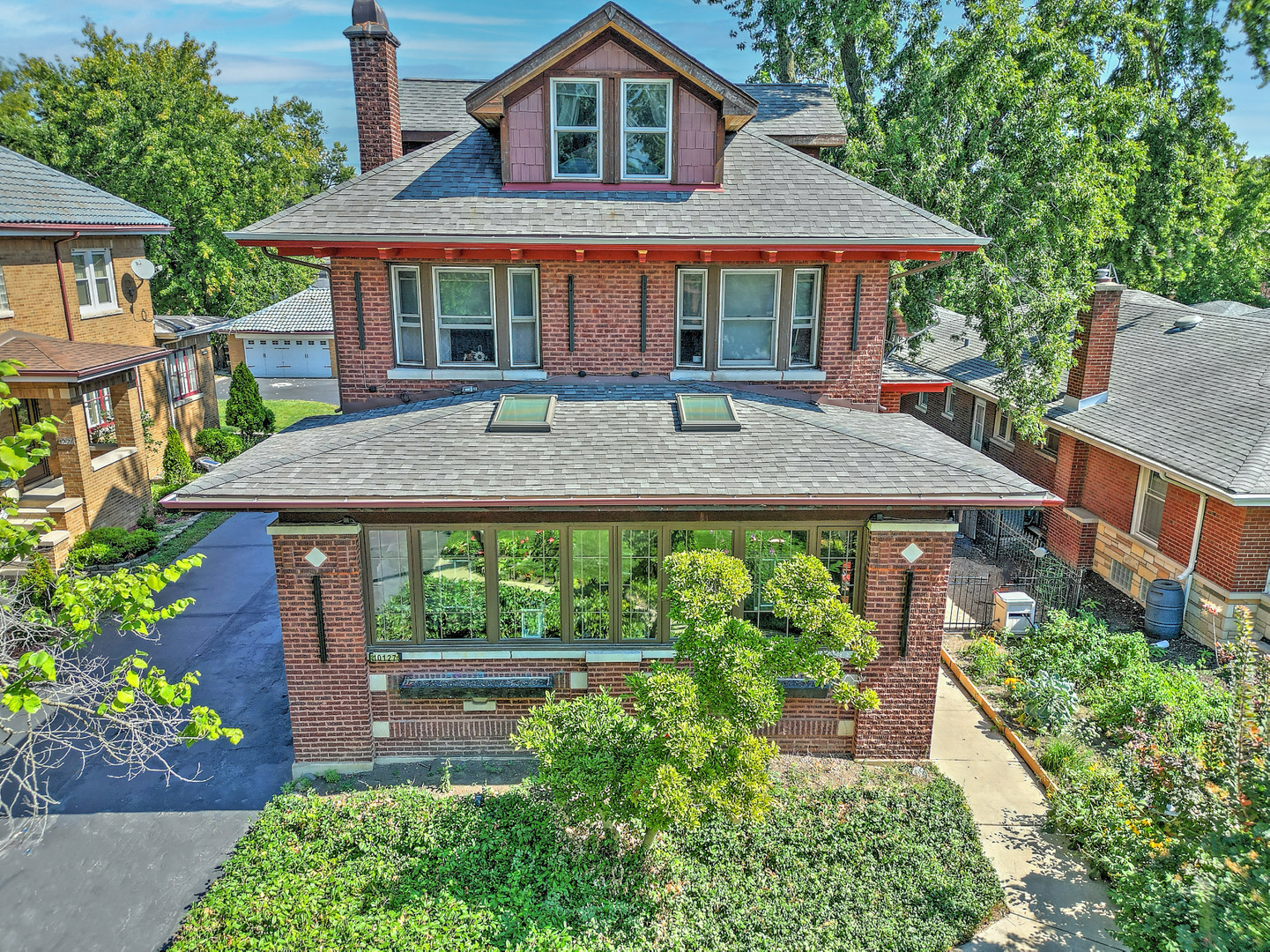 A Rare Beverly Gem!!! Built in 1911 by the president of Sears Roebuck, this extraordinary 4-bedroom, 3-bath, 3,469 sq. ft. estate sits on an oversized 60' x 191' lot and has been meticulously restored to its original beauty with modern updates. Previously featured on the Beverly Home Tour and Garden Walk, the home blends historic craftsmanship with contemporary elegance. Constructed with triple-wythe brick walls and steel structural supports, the home was built with the finest Sears Roebuck materials of the time. Inside, you'll find mission-style oak staircases, high ceilings, elegant fluted moldings, ornate radiators, and stained-glass windows. Vintage details like a built-in phone booth, antique mission-style furnishings, and crown moldings showcase the home's character. The west-facing living room features a wood-burning fireplace framed by stained glass. A sunroom with mission-style windows and a gas fireplace invites natural light and evening sunsets. The chef's kitchen offers a granite island, double convection ovens, French door refrigerator, tall bi-tone cabinetry, and opens to a formal dining room accented by a copper ceiling and original built-in buffet. Three bedrooms include a primary suite with bay window, whirlpool bath, custom vanity, and a private glass-wrapped office. The spa-like hall bath features a steam shower with four showerheads. Cedar-lined closets provide storage throughout. Recently renovated, the third floor offers a bright entertainment space with skylights, a bedroom, storage, and a spa-like bath with a stone shower floor, marble vanity, and makeup counter. The basement provides abundant storage, laundry with dual washer/dryers, tool room, pantry, and workspace. The backyard is a true retreat. A 1,200 sq. ft. brick patio includes a stone grill, vintage pergola with Bluetooth sound, koi pond, waterfall, and fire pit. Beyond a trellis, enjoy a 15' x 30' pool with custom composite deck, tiki bar, and ample lounge space. A two-car garage completes the property. Beverly is known for its architectural charm, cultural events, and community spirit. Enjoy nearby dining, breweries, shopping, art, and the South Side Irish Parade. Convenient access to Metra and CTA make commuting easy while preserving a small-town feel in the city. This once-in-a-generation Beverly estate offers historic beauty, modern amenities, and a resort-style backyard oasis. Don't miss this rare opportunity.