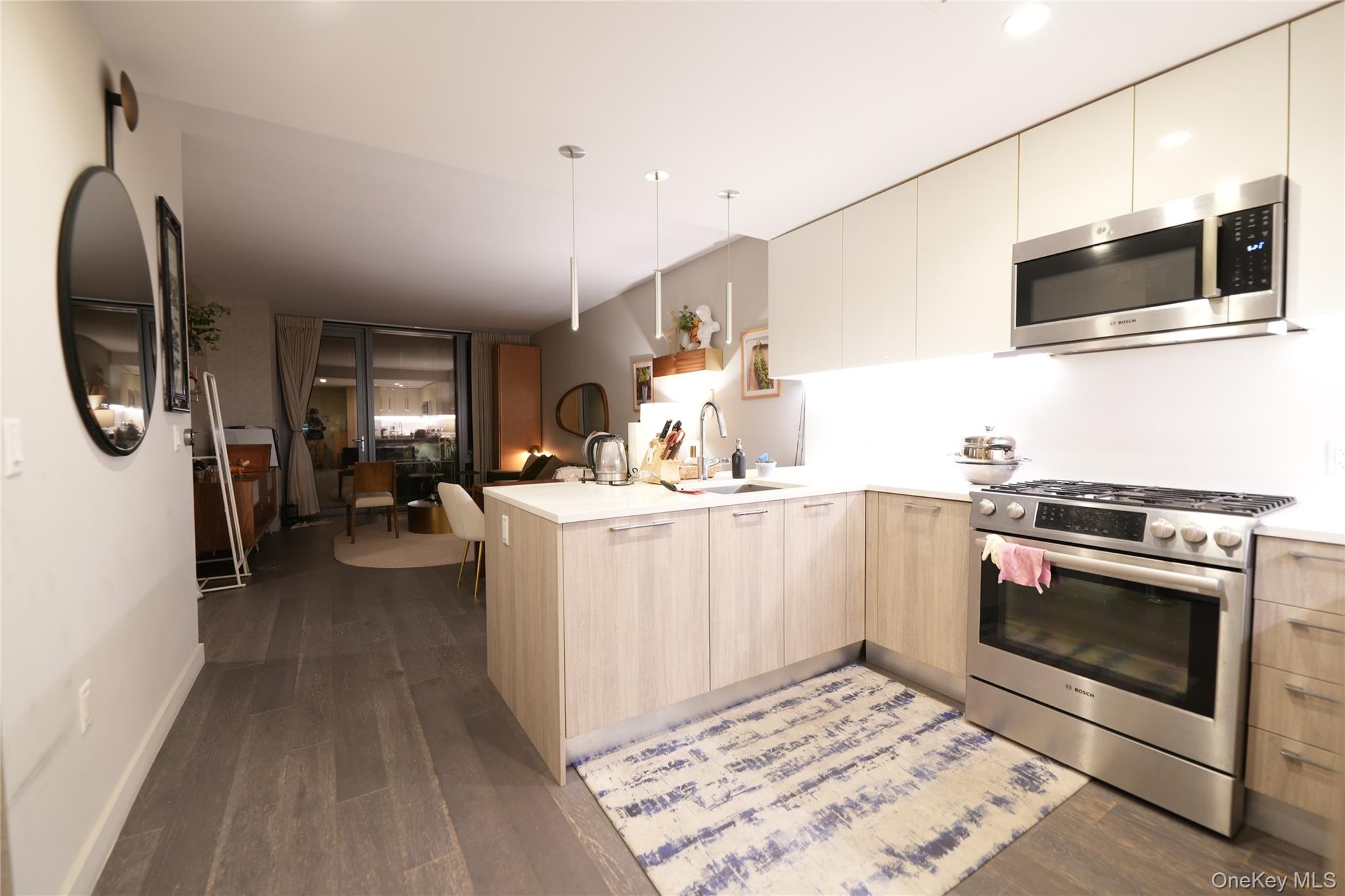 Welcome to this beautifully appointed two-bedroom condo in the prestigious Sky View Parc community. This south-facing home features bright, sunlit interiors, hardwood floors, and high ceilings that create a spacious, modern feel. With 1,043 sq. ft. of interior space and an in-unit washer and dryer, this residence offers both comfort and convenience.Residents enjoy first-class amenities including a 24-hour doorman and concierge, rooftop garden with BBQ grills, fitness center and spa, running track, sports courts, and a children’s playground.Ideally located near the #7 subway, LIRR, bus lines, and premier shopping, this home offers the perfect blend of luxury and lifestyle in the heart of Flushing.Experience effortless urban living