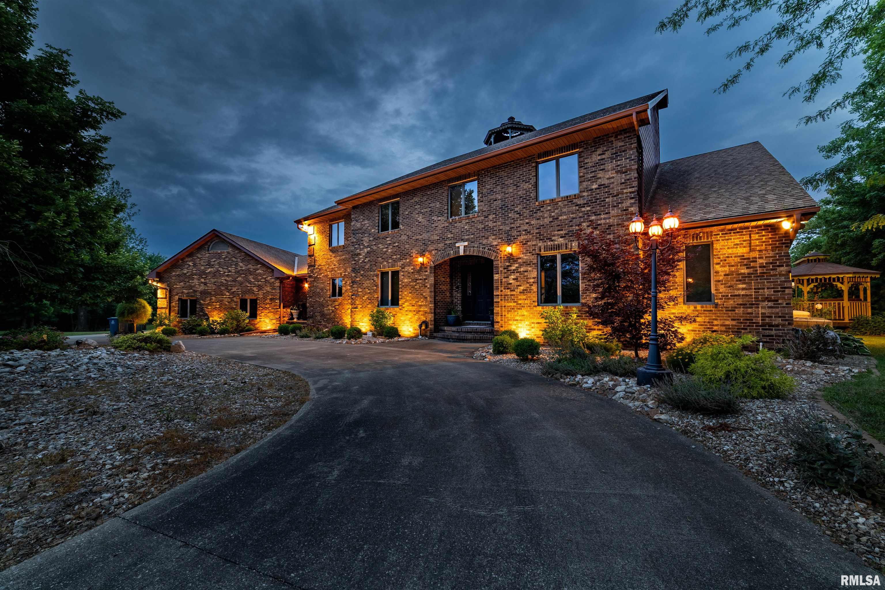 Stunning 5-Bedroom Home with Breathtaking Mississippi River Views. Nestled on a picturesque 7-acre bluff, this elegant brick 2 story home offers a perfect blend of luxury and tranquility. With 5 beds, 3 full baths, and 2 half baths, this residence is designed for both comfort and style. As you enter, you are greeted by an inviting foyer that leads to expansive living areas filled with natural light. The open-concept layout seamlessly connects the dining and living spaces, making it ideal for entertaining. The home features an all-glass elevator that provides easy access to all levels, allowing for effortless movement throughout the residence. For added enjoyment, the finished basement features entertainment rooms that are perfect for movie or game nights, complete with a cozy wood-burning fireplace that adds warmth and ambiance. A unique 3rd story lookout tower offers panoramic views of the Mississippi River and the surrounding landscape, making it a perfect spot for relaxing or enjoying a sunset. This property also includes an oversized 3-car attached garage as well as a 30x50 outbuilding. Recent updates enhance the appeal of this home, including a new roof  installed in 2017, 2 water heaters new in 2019, and neutral paint throughout in 2024. The hardwood flooring, carpet, and tile were new in 2024. Step outside to enjoy the park-like outdoor space. The expansive property provides plenty of room for outdoor activities, or simply enjoying the beauty of nature