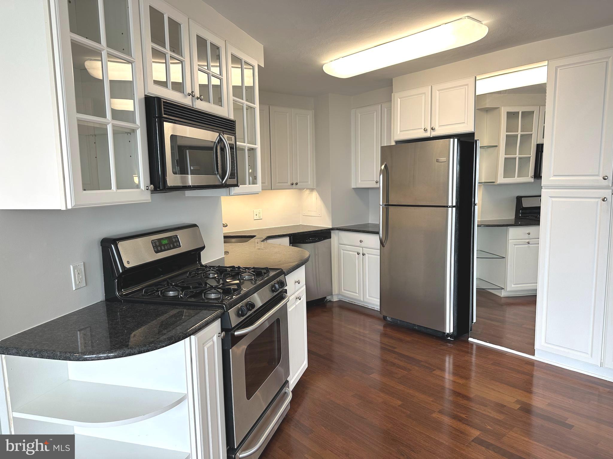 You will love living at Sutton Terrace! It is luxurious living with amenities,  friendliness and the feeling of being on vacation year round. This 1322 square foot 1 bedroom + den is mostly used as a 2 bedroom condo has 1 ½ baths and was reconfigured to enhance the openness of the condo.There is a 24/7 door person building with excellent support staff to help you with packages, groceries and other needs.  As you step into the property, there is a wide open space allowing you to see the entire wall of windows and views beyond. The gleaming dark wood floors are the perfect backdrop for elegant rugs. The property was just painted in designer colors and the bedroom/den are newly carpeted with lovely soft neutral colors. The handsome black granite countertops and white kitchen cabinets in the kitchen floor plan were redesigned to maximize the efficient use of the space. The slight curve and the way it is contiguous to the kitchen gives the dining area character.  It has windows for air flow on nice weather. The wall scones and dining room fixture provide subtle, soft lighting. There is a gracious flow of the dining room into the living room. The long end of the living room can be used as another sitting area or a dining area. The view from this 9th floor allows you to see over the treetops and the city in the distance. Take the hallway to the left, the den /2nd bedroom is on your immediate right with a full closet. The hall continues to a linen closet on the right and a big walk in closet on the left. The wash/dryer is on your left. As you walk ahead, the angled door to the bathroom leads to the enlarged bathroom. The long vanity and counter have plenty of storage. Look at that beautiful glass wall in the enlarged shower! This shower is easy to use and has so much space. The primary bedroom is roomy and has another wall of windows. The library and fitness center are on the first floor. The newly redecorated social room is used for meeting, speakers, playing cards, games and entertainment. The grounds have lush plantings and are well kept. A beautiful new fence was installed around the perimeter of the lot. The location of the building has easy access to the city, suburbs and airport. Shopping is right across the street. It is a beautiful neighborhood to live in with charming homes nestled close to mature trees and plantings. The pool is open to everyone for a $145 per member. The indoor garage spaces when available (currently available) are $150/month. There is a $2500 refundable move in fee after living at Sutton Terrace for 30 months. The condo fee is $1292/month which includes $971 monthly association fee + capital reserve fee of $143 + masonry loan of $146 until 2/28, and $32 for electric.