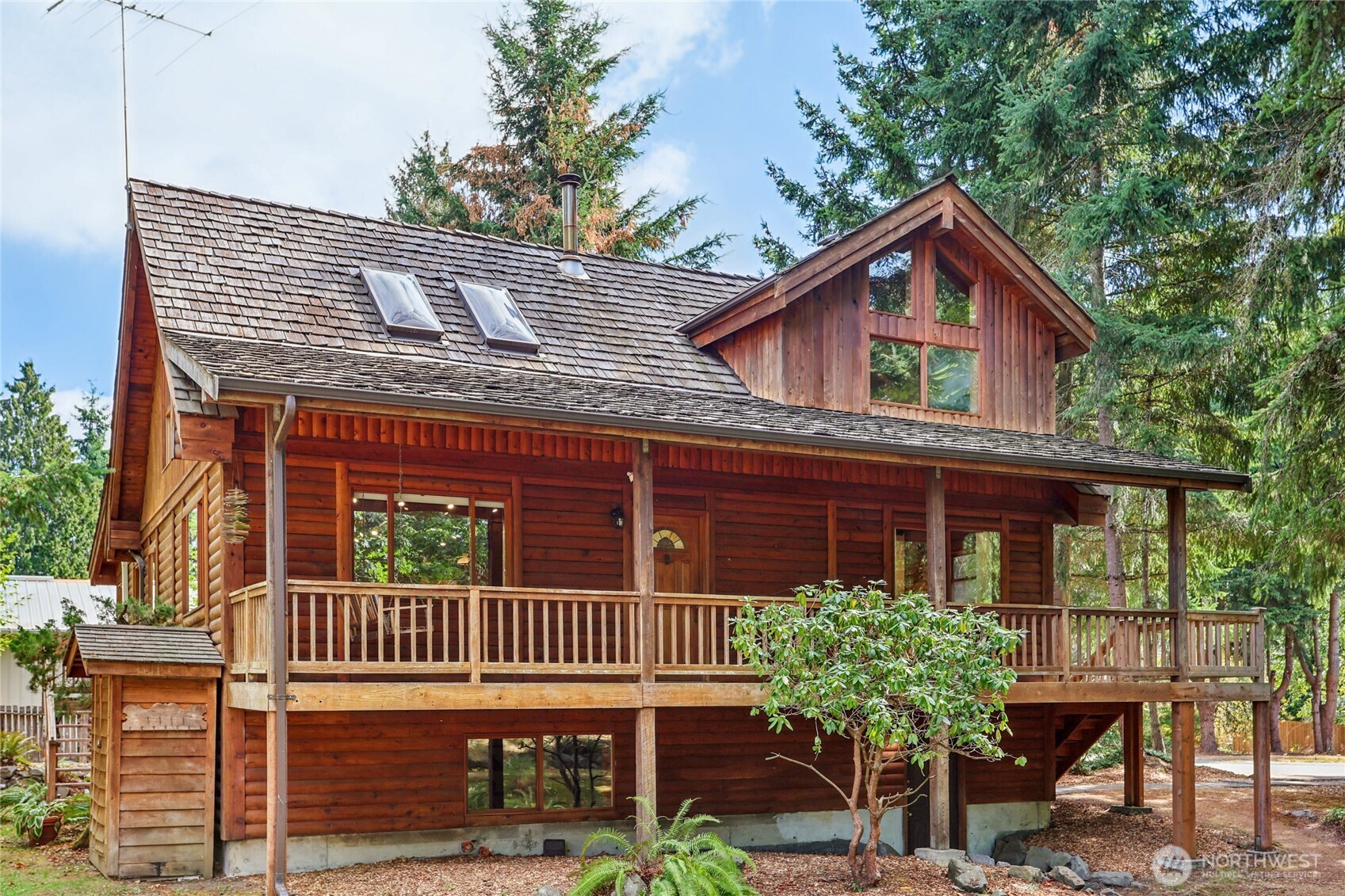 Escape to a rare sanctuary on a spectacular 13,939 sq ft lot. This unique three-level PNW log-style home blends rustic charm and modern living, featuring vaulted ceilings, skylights, and windows that flood the space with light. The 2,958 sq ft layout includes 3 bedrooms, 1.75 baths, a loft, and two bonus rooms—perfect for a home office, media room, or a gym. The walk-out basement adds versatility. Outside, the landscaped grounds are a masterpiece with a seasonal stream, pond, gazebo, and fruit trees. A greenhouse and shed are ideal for the avid gardener. Relax and entertain on the generous deck. Enjoy easy access to I-5 & I-405 and the top-rated Northshore School District. Don't miss this one-of-a-kind log home.