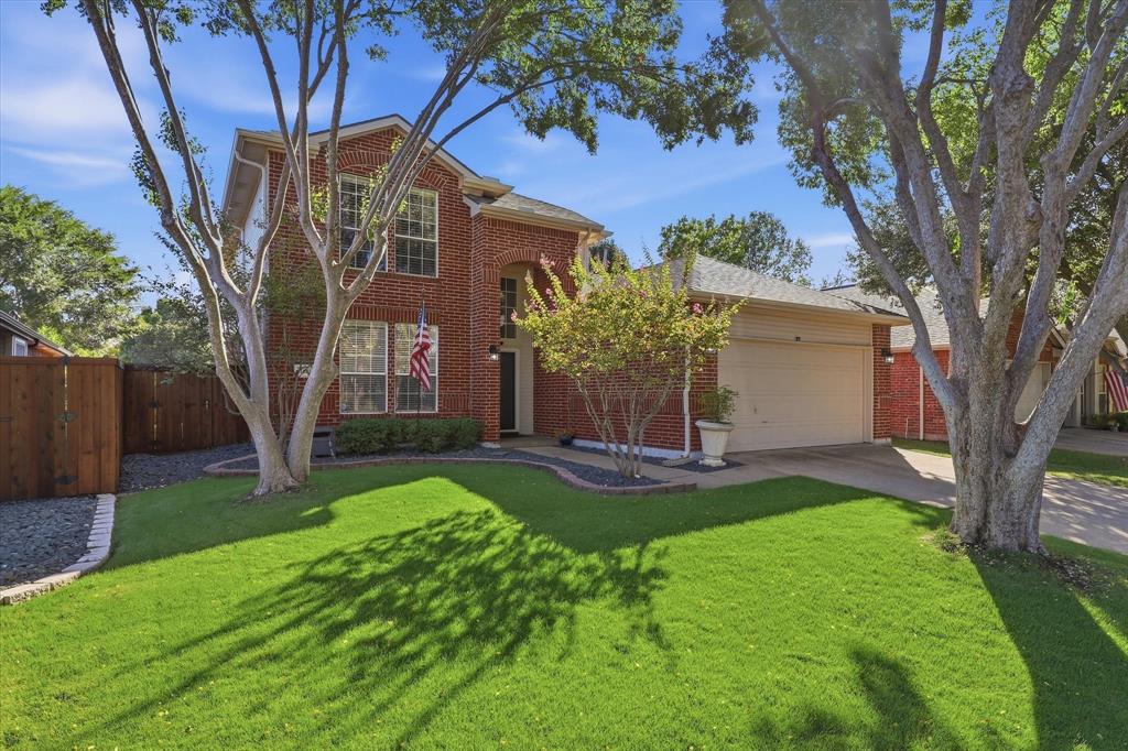Framed by mature trees & backing to an expansive greenbelt, 1481 Royal Oaks Drive blends bright, inviting interiors with thoughtful updates in the heart of Waterford Falls and in Frisco ISD! This north-facing home enjoys a peaceful greenbelt backdrop, with expansive open space for play & walking trails for evening strolls. Community pools & playground are just a short walk away along the greenbelt—all the enjoyment of a pool without the upkeep! Inside, a two-story foyer, neutral color palette & luxury vinyl plank flooring throughout the first floor create a cohesive and welcoming feel. Tall windows bring natural light into the dining room, providing a comfortable setting for everyday meals & special gatherings. The expanded kitchen pairs classic white cabinetry with a contrasting navy island, adding storage, seating & generous space for meal preparation. Updated countertops, a mosaic backsplash, decorative lighting & stainless-steel appliances, including a gas range, complete the space. The adjoining breakfast area overlooks the backyard, while the open connection to the family room keeps conversation flowing. A fireplace with a crisp white mantel anchors the family room, where a wall of windows draws the outdoor setting inside. The secluded downstairs primary suite features an updated bath with dual sinks, a soaking tub & a separate glass-enclosed shower accented by decorative tile. Upstairs, two additional bedrooms, a full bath & a spacious flex room enclosed by French doors offer versatility for a game room, media room, home office or additional bedroom. Outside, an extended covered patio provides ample room for lounging, dining & gathering. A neatly trimmed hedge adds privacy along the rear fence, with gated access to the greenbelt & walking trails. Beyond the neighborhood, enjoy convenient access to PGA Frisco, Legacy West, The Star, H-E-B, Toyota Stadium & downtown Frisco shopping & dining, plus Sparks Elementary School within walking distance.