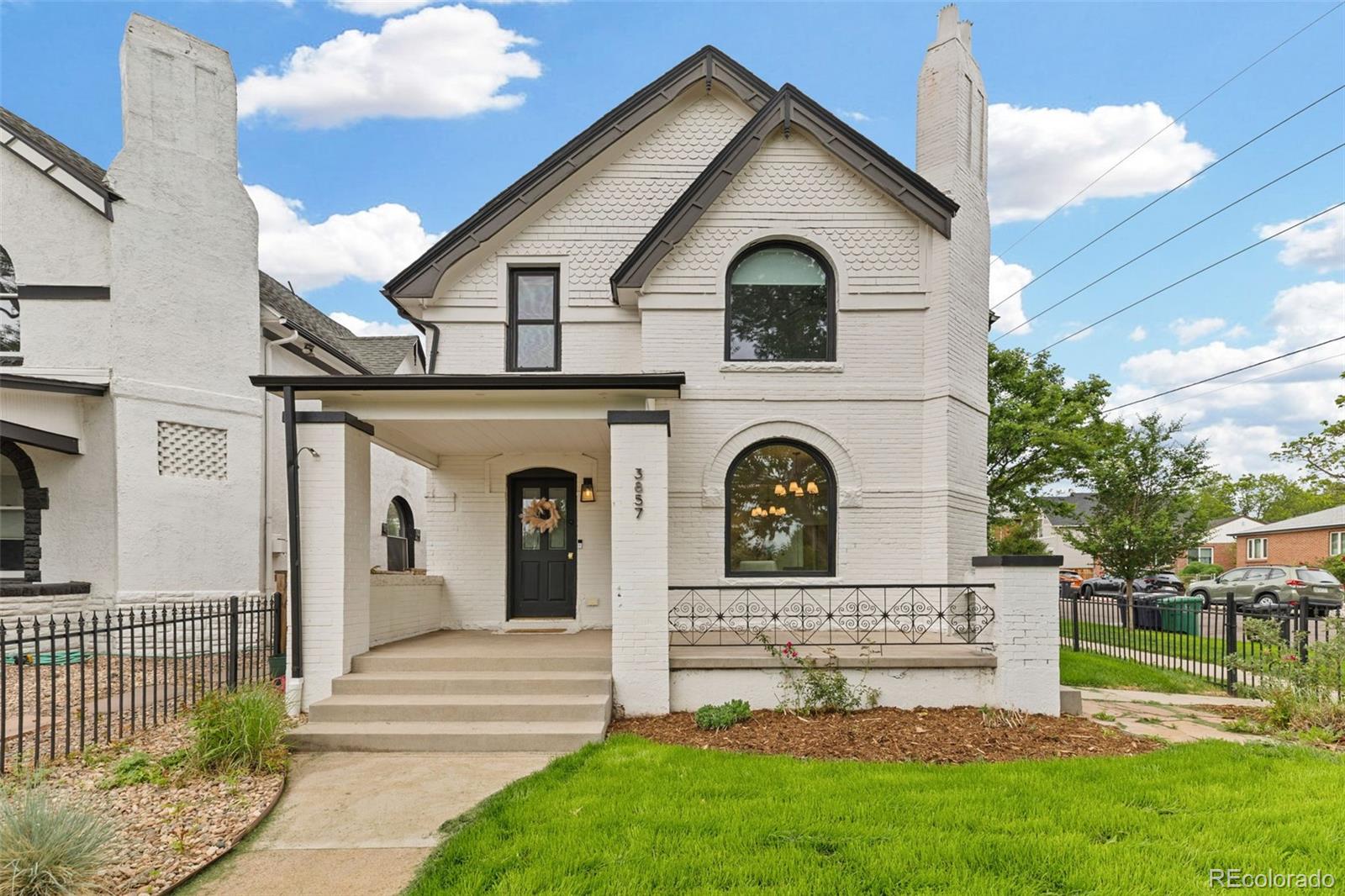 This fully restored 1891 Victorian home in Denver's vibrant Sunnyside neighborhood seamlessly blends period detail with a design-focused renovation featured in Modern in Denver and Luxe Magazine. Soaring ceilings, arched windows, designer lighting (GUBI, Cedar & Moss, Schoolhouse) and a classic fireplace anchors the main level for effortless living and entertaining. Chef’s kitchen boasts a 12-foot marble waterfall island, commercial dual-fuel range, Galley workstation, custom William Ohs cabinetry, Ann Sacks tile and Carrara marble throughout. Luxe primary suite offers a walk-in closet and spa-like bath with heated marble floors and steam shower, while two additional bedrooms are served by a stunning guest bath featuring an original claw-foot tub, custom brass Sign of the Crab fixtures, handmade cement tile and custom walnut-and-marble vanity. Outdoor living shines with an elevated front porch and vine-covered pergola over a spacious back patio, surrounded by designer landscaping curated to bloom across Colorado’s three-season growing period.