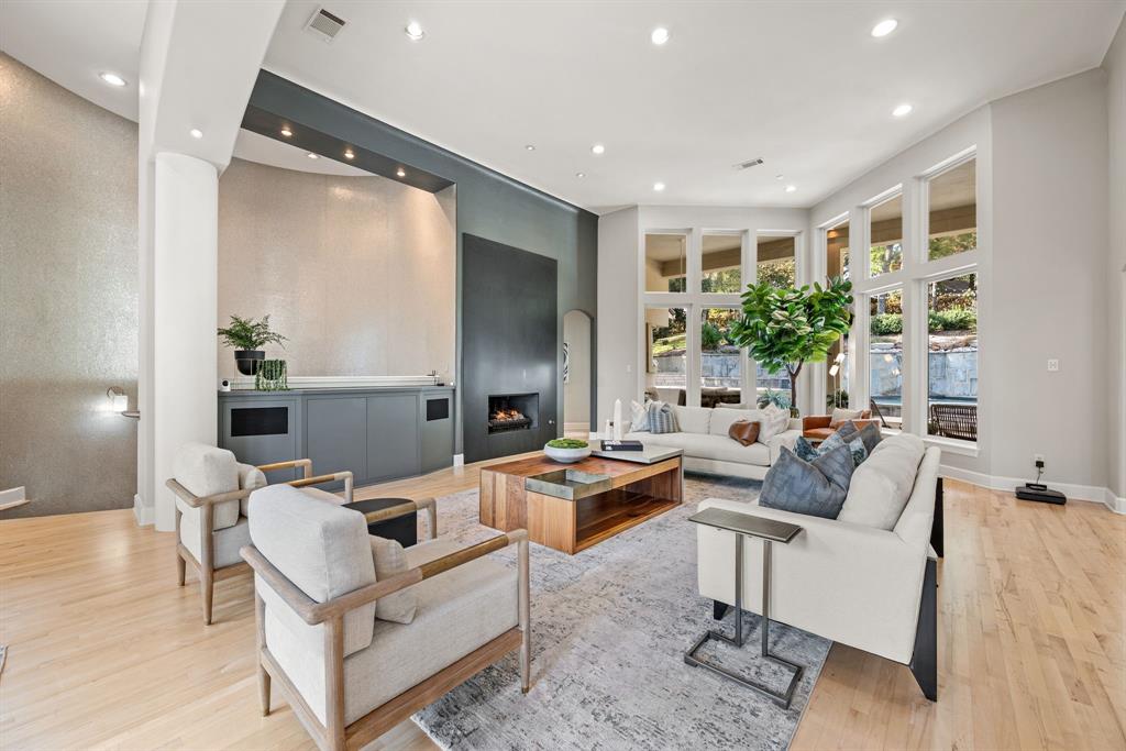 Wide-open views! One of a kind custom home perched atop a scenic hillside, this MOVE IN READY updated stunning residence built by Bailey Draper captures sweeping views and timeless elegance. This property is one of a kind! Set on over half an acre, this unique modern home blends sophistication with comfort—perfect for both everyday living and grand entertaining. Step through the impressive entryway onto beautiful hardwood floors that flow throughout the open-concept main level. Expansive terraces and soaring ceilings fill the home with natural light, creating a bright, inviting atmosphere. The formal study and dining room each offer terrace access, ideal for indoor-outdoor gatherings. The gourmet kitchen is a chef’s dream, featuring a built-in refrigerator, gas cooktop, stainless steel appliances, quartz countertops, and a spacious island. The private primary suite offers its own balcony access and a see-through fireplace leading into a spa-inspired bath with a jetted tub and glass shower. Entertainment spaces abound—including a game room, media room, and convenient kitchenette—all accessible by elevator. Generously sized secondary bedrooms provide comfort and privacy for family and guests alike. The Exercise Room could be a 5th bedroom with a walk-in closet and en suite bath. Outside, the covered patio overlooks a sparkling pool and attached spa, with an outdoor fireplace creating the perfect setting for year-round relaxation and entertaining. Located in award-winning Grapevine-Colleyville ISD, this exceptional home combines luxury, function, and unforgettable views in one extraordinary package. Conveniently situated between Dallas and Fort Worth, as well as excellent access to the Dallas Fort Worth International Airport. Within minutes of Historic Downtown Grapevine and Southlake Town Square offering endless dining and shopping options!