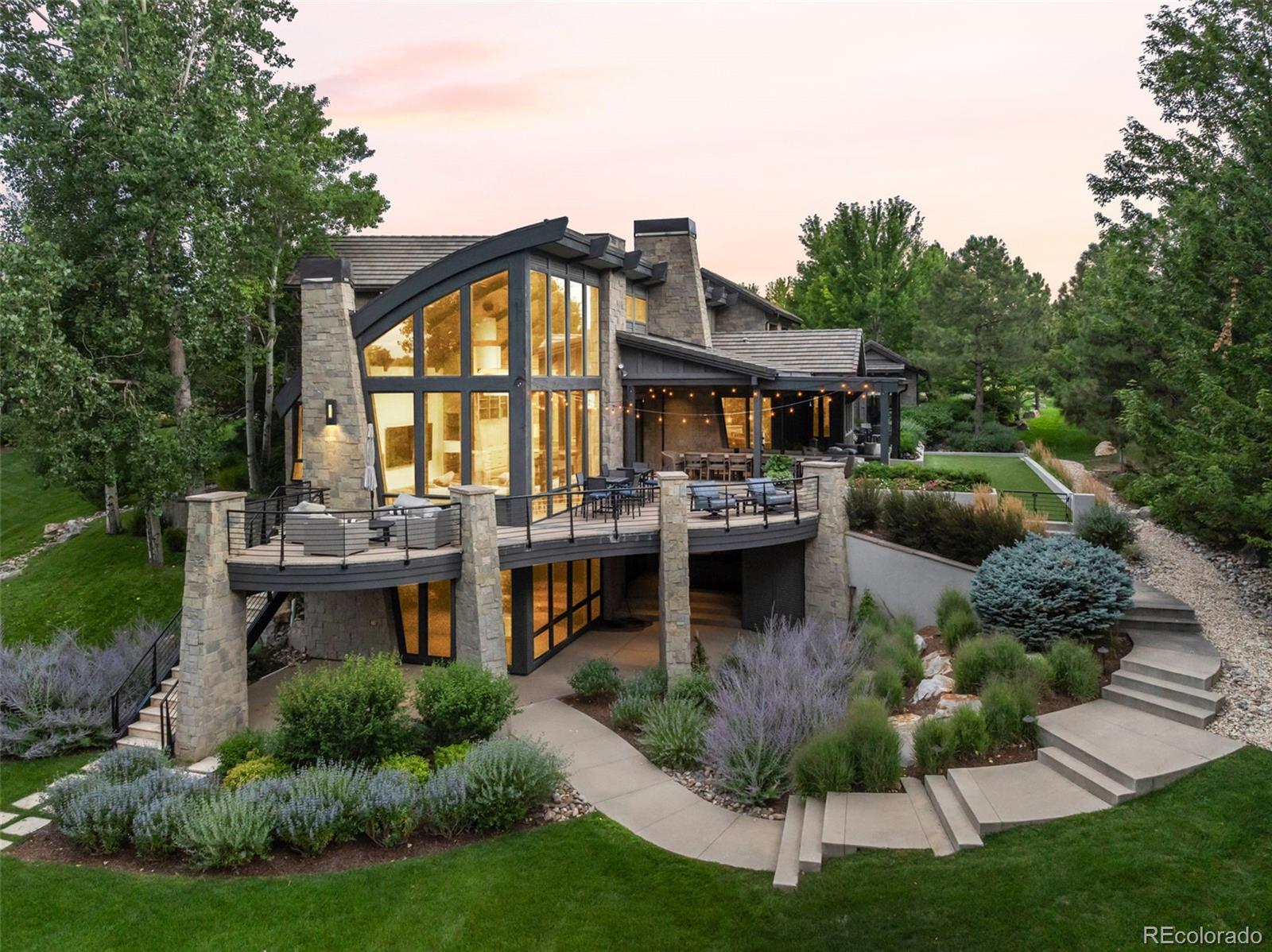 Set on one of the most coveted corner lots in The Preserve, 4201 Preserve Parkway North is a true architectural masterpiece backing to the High Line Canal and offering exceptional privacy. Designed by acclaimed architect Mike Woodley of Woodley Architectural Group as his personal residence, this extraordinary home is both a statement of design and a livable work of art.Recognized at the highest levels, the home was awarded the prestigious Bar Award by the Denver Home Builders Association for Best Custom Home in Denver, as well as a national honor from the NAHB for Best Custom Home in the United States.Originally built and thoughtfully reimagined by Woodley in 2019, the residence was intentionally designed to “unfold” as you move through it—revealing a series of stunning spaces, each more captivating than the last. Expansive floor-to-ceiling windows flood the home with natural light and seamlessly connect the indoors to its serene surroundings.An entertainer’s dream, the home offers a seamless flow from indoor to outdoor living with gathering spaces at every turn. Enjoy year-round resort-style amenities including a heated pool, hot tub, firepit, and multiple outdoor areas designed for both intimate evenings and large-scale entertaining. This home also features a 6 car garage.Rich in architectural detail, the home blends striking materials such as stone with a refined, modern aesthetic, creating a one-of-a-kind living experience. Every element has been carefully curated to deliver both visual impact and everyday comfort.This is a rare opportunity to own a nationally recognized home where design, setting, and livability come together in perfect harmony.