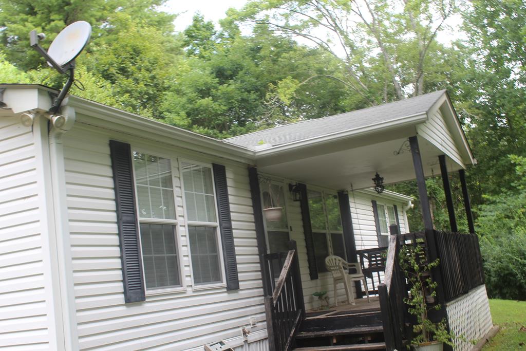 Nice home tucked away with privacy. Handicapped accessible with exterior ramp on the back of home. Easy to maintain yard, small utility building at side of home.Home is being sold furnished along with security camera system.