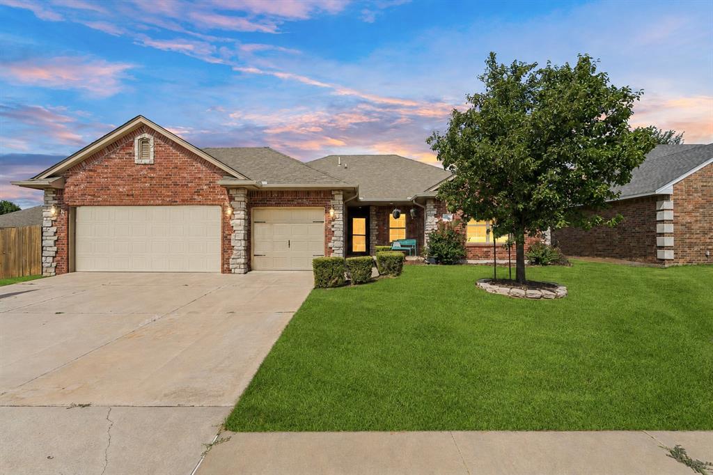Fabulous well taken care of home in Moore with quick access to I-35 and downtown Moore! Situated on a desirable corner lot, this home features a spacious living room with a cozy fireplace and beautiful laminate wood flooring. The large dining area opens to a stunning kitchen offering an abundance of cabinetry, granite countertops, stainless steel appliances, a built-in microwave, and under-cabinet lighting. The thoughtfully designed split floor plan provides privacy, with two spacious secondary bedrooms and a full bath on one side of the home, while the private primary suite is tucked away on the opposite side. Both secondary bedrooms feature walk-in closets, and the hall bath offers granite countertops. The spacious primary suite includes a luxurious en-suite bath with double granite vanities, a jetted Jacuzzi tub w/ shower, and an oversized walk-in closet.Step outside to enjoy the covered patio complete with retractable patio shades, making it the perfect space for relaxing or entertaining. The backyard also features a metal storage building, an 10 person in-ground storm shelter, and a double gate for convenient backyard access. The oversized three-car garage includes rear-facing double doors, providing easy access to the backyard and added flexibility for lawn equipment, hobbies, or additional storage.  Located in a smaller, well-kept neighborhood, you'll enjoy being just 5 minutes from Moore schools, shopping, dining, parks, and everyday conveniences.