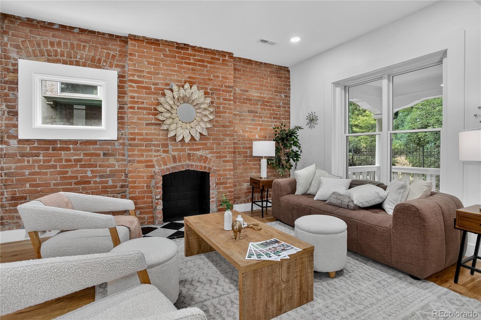 Located in the heart of the East Seventh Ave Historic District, this beautifully updated Denver Square blends classic charm with modern luxury in the most seamless way. From the moment you step inside, the restored wood bench and original stair railing and exposed brick set the stage for the craftsmanship & character that define this home.The main level is made for entertaining, featuring an open layout, anchored by a fully remodeled chef’s kitchen. You’ll love the 6-burner gas range, custom cabinetry, walk-in pantry, and built-in outlets! A bright and airy flex space opens through two sets of new Pella sliding glass doors to the covered patio and private backyard— A half bath adds convenience without sacrificing style.Upstairs, the primary suite is a true retreat + a terrific size! Enjoy a spa-inspired ¾ bath with floor-to-ceiling marble tile, a custom walnut dual vanity, an oversized walk-in closet (design it your way with a seller concession!), and private laundry. Two additional bedrooms and a beautifully updated full bath with a double vanity complete this level.The finished basement with its own private entrance offers incredible versatility—ideal for guests, in-laws, or multigenerational living. It features a large bedroom with egress, a ¾ bath, living area, kitchenette, and second laundry setup.Outside, you’ll find a serene backyard with mature trees, lush grass, a blooming hibiscus tree, and a spacious covered patio perfect for outdoor dining.  You have a garage and large RV/extra parking as well!This home has been renovated top to bottom, including new double-pane wood windows, wood sliding doors, hardwood floors, roof, AC, furnace, plumbing, electrical, sprinklers, and more. The finished basement—HAS ITS OWN ENTRANCE—functions perfectly as a guest suite or multigenerational living space, offering a large bedroom with egress window, ¾ bath, living area, kitchenette, and second laundry.