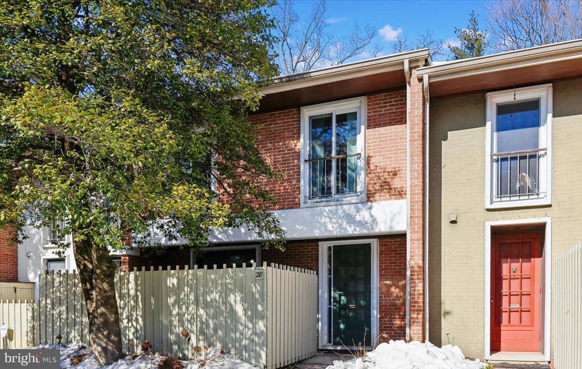 Nestled in a quiet, peaceful section of the sought-after gated Village of Cross Keys, 28 Bouton Green Court offers comfort, style, and privacy in one of Baltimore’s most desirable communities. This well-loved townhouse-condo features three bedrooms, two and a half baths, and thoughtful design throughout.The main level showcases parquet flooring, oak stairs, and ceramic tile accents in the kitchen. The sun-filled kitchen offers gas cooking and views of the front courtyard—an ideal spot to enjoy outdoor dining. The dining and living areas flow seamlessly, creating an inviting space perfect for entertaining. The spacious living room features a cozy wood-burning fireplace and opens through sliding glass doors to a private patio, a serene retreat for relaxing, gardening, or reading. Upstairs, the light-filled primary suite includes a private en-suite bath and dressing area.  Down the hall, you’ll find a laundry closet with storage and a cheerful hall bath. Two additional bedrooms offer hardwood flooring, ample closet space, and custom built-ins.Residents enjoy an exceptional lifestyle with access to three swimming pools, tennis courts, a clubhouse, walking paths, and upscale shopping and dining. Conveniently located just minutes from downtown Baltimore and surrounding county destinations, this gated enclave provides the perfect balance of tranquility and accessibility.  Cross Keys living is easy to love—and even easier to call home!