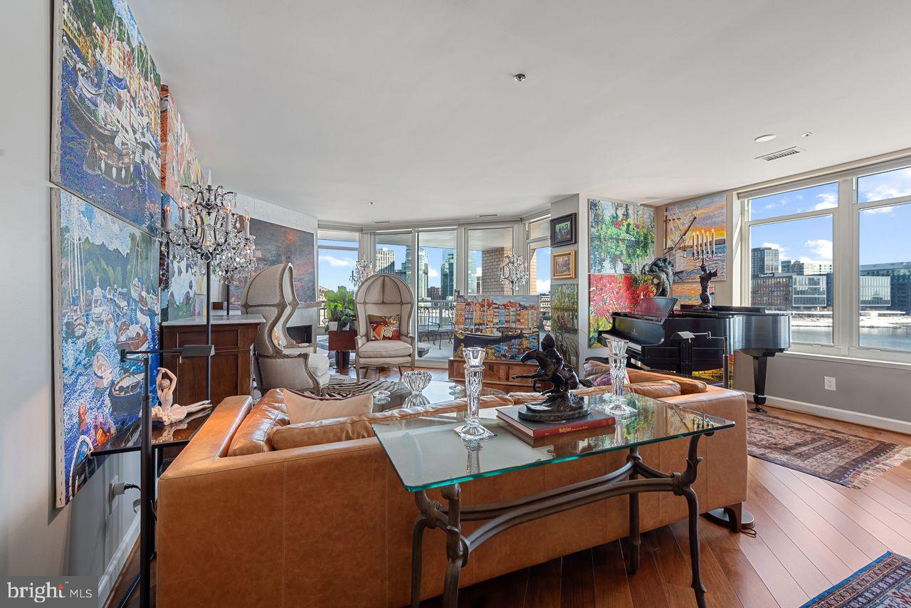 Amazing Inner Harbor views and sophisticated urban living... nothing surpasses this beautifully renovated two bedroom - two bath condo in the amenities-rich Harborview Towers. An oversized deck overlooking the Patapsco River and the magnificent Inner Harbor skyline provides privacy and breathtaking views. Like fireworks? This is your front row seat to the New Year's Eve and 4th of July fireworks and on-going celebratory sights - including  the Lighted Boat Parade and Fleet Week ships. High-end and elegant materials enhance the beautiful open floor plan with hardwood floors throughout. The fully renovated unit offers two bedrooms with spectacular views and two elegant baths. A gourmet kitchen with oversized island and ample storage opens to the entertainment area boasting a beautiful electric fireplace and accessing the covered deck.  Prepare to be spoiled by the owners' en suite with amazing views,  walk-in closet, soaking tub and separate shower, heated flooring  and heated towel racks! Building amenities include indoor and outdoor pools with locker rooms and showers, a multi-purpose health club with circuit weight machines, free weights, ellipticals, bikes and treadmills. But amenities don't stop there. Multiple party/entertainment rooms with billiards table, a fireplace lounge, well-appointed boardroom for meetings, and a walled grille-garden facing east to the river and the Domino Sugars sign add to the many entertainment options available to residents.  There’s an attentive 24/7 front desk with concierge service, a gated underground garage, valet parking for guests, and guest suites available to rent by reservation. And located just a stone's throw from all the Inner Harbor has to offer - restaurants, events, attractions, concerts, parades, farmers' markets... the list goes on. This is the one you've been looking for!