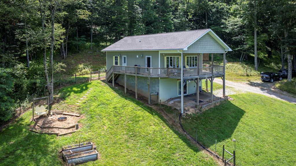 Lake View Home in Blue Ridge Mountains. This 2 bed/ 2 bath home on 6.72 acres has fantastic view of Hidden Valley Lake and the surrounding mountains. Lots of large windows and a nice wide front porch make this home perfect for enjoying the outdoors inside or out. This is a quality built, custom home with great features including solid oak flooring and 30 year architectural shingle roof . A heated, walkout basement that also has access from the inside is very close to being finished out and could double the finished square footage. There is a very nice 20x30 shop on the property that has power and heat. This could also be used as storage. A lovely fenced in yard has a firepit and some raised beds to do a little gardening. This property is located just minutes from the town of Independence Va and in close proximity to many recreational opportunities.