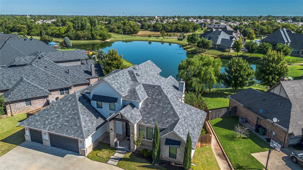 Breathtaking luxury residence nestled in one of Edmond’s premier gated neighborhoods. This stunning waterfront home showcases elegance at every turn with soaring ceilings, massive bedrooms, and designer fixtures that elevate everyday living into a refined experience. Step inside and be greeted by an expansive floor plan that flows seamlessly into a chef’s kitchen built for entertaining, complete with high-end finishes and an abundance of space. The home’s thoughtful design includes a mother-in-law suite, providing privacy and comfort for extended family or guests. Outdoors, enjoy not one but two covered patios overlooking the serene water, creating the perfect setting for relaxation or gatherings with friends. A circle driveway and 3-car garage offer both convenience and curb appeal, while the community’s resort-style amenities — including scenic lake, a sparkling pool, recreation facility, neighborhood park, and winding walking trails — make every day feel like a retreat. This extraordinary property embodies luxury, comfort, and lifestyle in the heart of Edmond. Don’t miss your opportunity to call it home. * Seller is in the process of having a new roof installed.