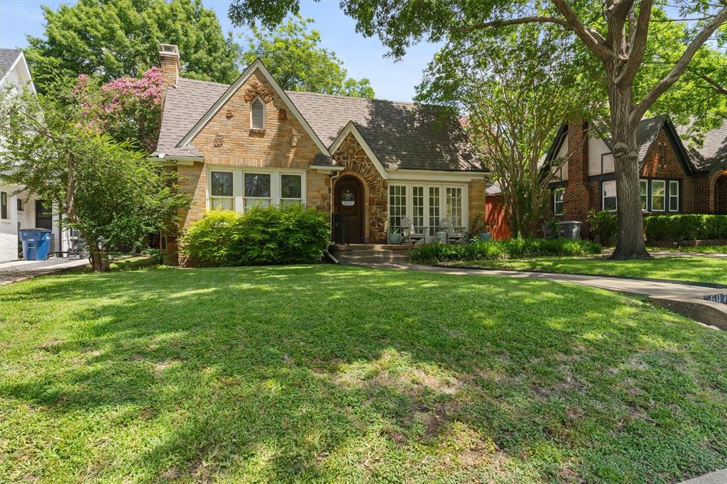 Welcome to 5607 Morningside Ave—a storybook Tudor nestled in one of Dallas’ most sought-after neighborhoods, just minutes from the vibrant city skyline. Brimming with curb appeal, this home features a classic arched entry, rich brick detailing, and mature trees that frame the lush front lawn and shaded walkway. Inside, the charm continues with original architectural details including arched doorways, elegant crown molding, stained glass windows, and gleaming hardwood floors. The cozy living room centers around a striking green marble fireplace and flows seamlessly into a formal dining space framed by French doors—ideal for entertaining. The kitchen blends function with style, featuring stainless steel double ovens, a built-in cooktop, sleek black countertops, and a custom island with marble top. A breakfast nook with built-in bench seating adds a touch of character and comfort. Just off the kitchen, a tucked-away utility area includes a wine fridge and stacked washer-dryer with access to the private backyard! Step outside to a secluded courtyard oasis with plenty of space to unwind or entertain under the canopy of mature trees. Located just blocks from local shops and restaurants in Lower Greenville, and some of Dallas’ most iconic neighborhoods, this gem combines timeless architecture with modern updates—all in a location that’s hard to beat! Schedule your showing today!