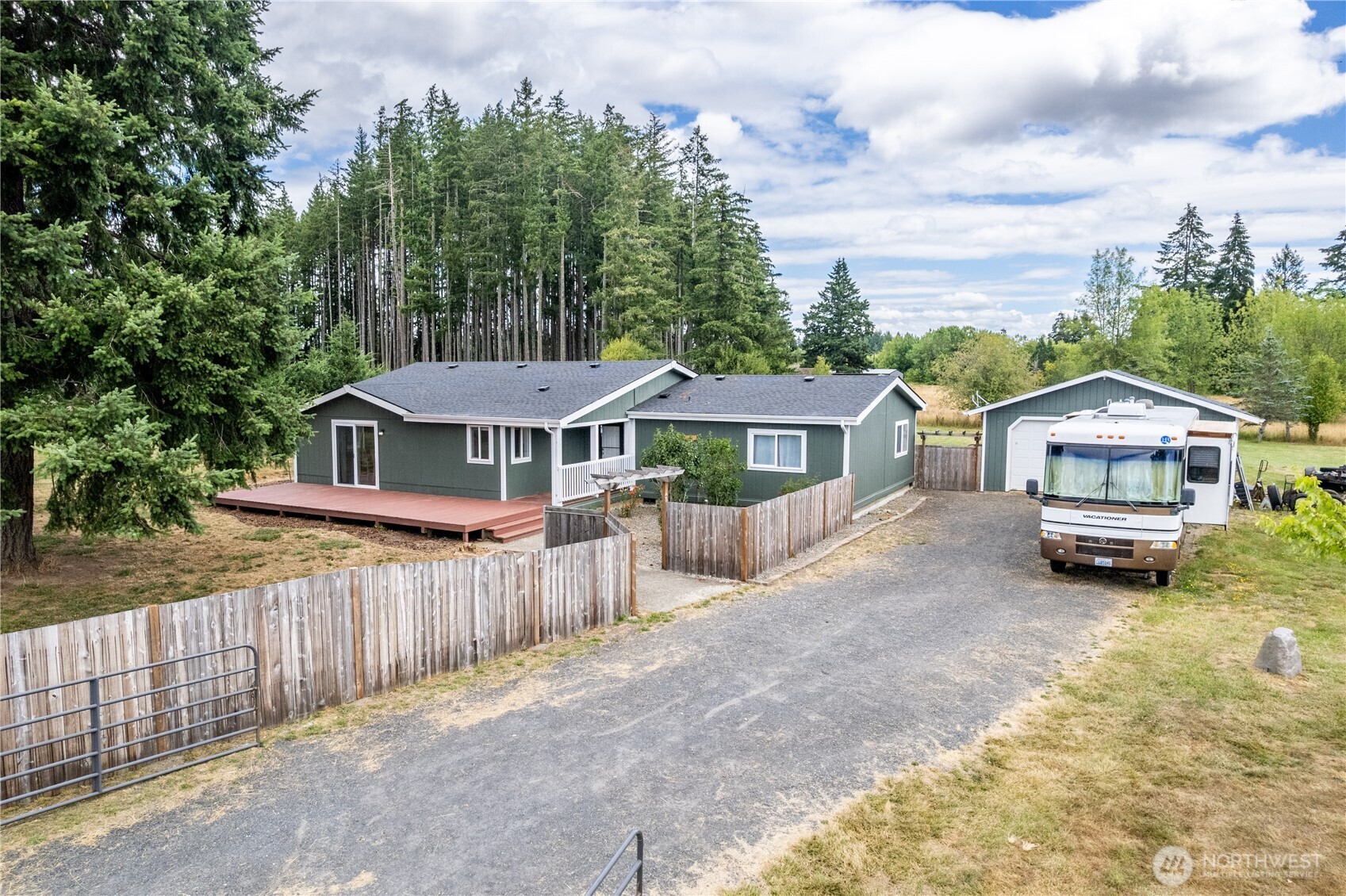Welcome home to this recently updated 3-bedroom, 2-bath home offering 1,876 sq ft of comfortable living space on 3.28 level, fully fenced acres. New roof, new paint, newly updated kitchen flows into a functional floor plan designed for everyday living and entertaining. Enjoy the flexibility of an oversized detached garage with 220 power, providing ample space for projects, hobbies, or storage. Outside you'll find plenty of RV parking, expansive yard space, a large deck for entertaining, garden areas, and a chicken coop ready for your hobby farm dreams. Private well and septic help keep utility costs low while offering the freedom of country living with room to spread out. A rare opportunity to enjoy acreage, functionality, and modern updates all in one property!
