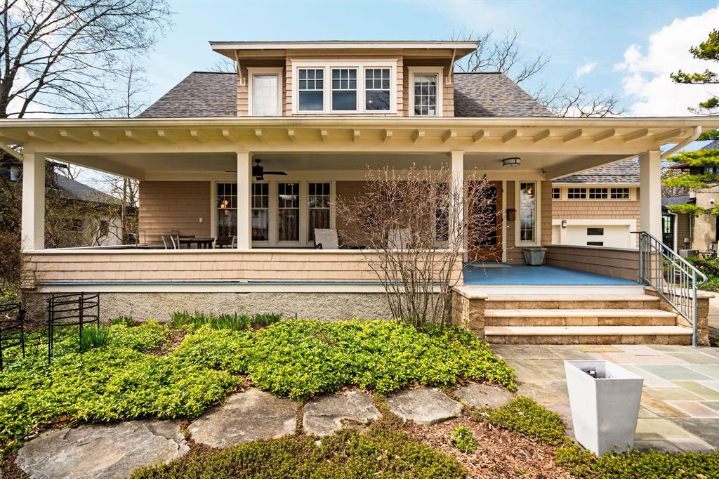 A rare blend of historic character and thoughtful, high-end renovation, this 1910 home offers timeless detail with modern livability just steps from the Arboretum and walkable to downtown Ann Arbor, the University of Michigan campus, and area hospitals. Original woodwork, rich architectural detail, and elegant proportions define the home, while every space has been carefully restored and enhanced. The expansive living room is both warm and refined, featuring a gas fireplace, beautiful natural light, and an easy flow into the formal dining room with custom built-ins. The dining space is perfectly scaled for entertaining, anchored by a custom table designed specifically for the room and included with the home. The designer kitchen is a true centerpiece, showcasing Motawi tile backsplash, Thermador appliances, a Wolf induction five burner cooktop, a beverage refrigerator, and a striking porcelain island paired with quartz countertops, all updated in 2023. Thoughtful updates include oakflooring and ceiling beams milled to seamlessly match the original woodwork, creating a cohesive and elevated feel. The kitchen opens to a large screened porch accessible from both the kitchen and dining room, offering a beautiful extension of the living space overlooking the patio, outdoor cooking area, and terraced gardens designed for ease and enjoyment. The main level continues with a convenient half bath, laundry room, and a private suite wing with a spacious bedroom and adjacent full bath featuring an barrier free shower. A well designed mudroom connects to the attached two car garage with an EV charger. Upstairs, the home offers exceptional flexibility with two bedrooms, a third room easily converted from its current use, and an additional finished space above the garage ideal for guests, work, or recreation. The upper suite includes extensive built-in storage, a large walk-in closet, and an ensuite bath. A second upstairs bedroom, currently used as an office, offers generous space and storage. Extensive updates include a new ro